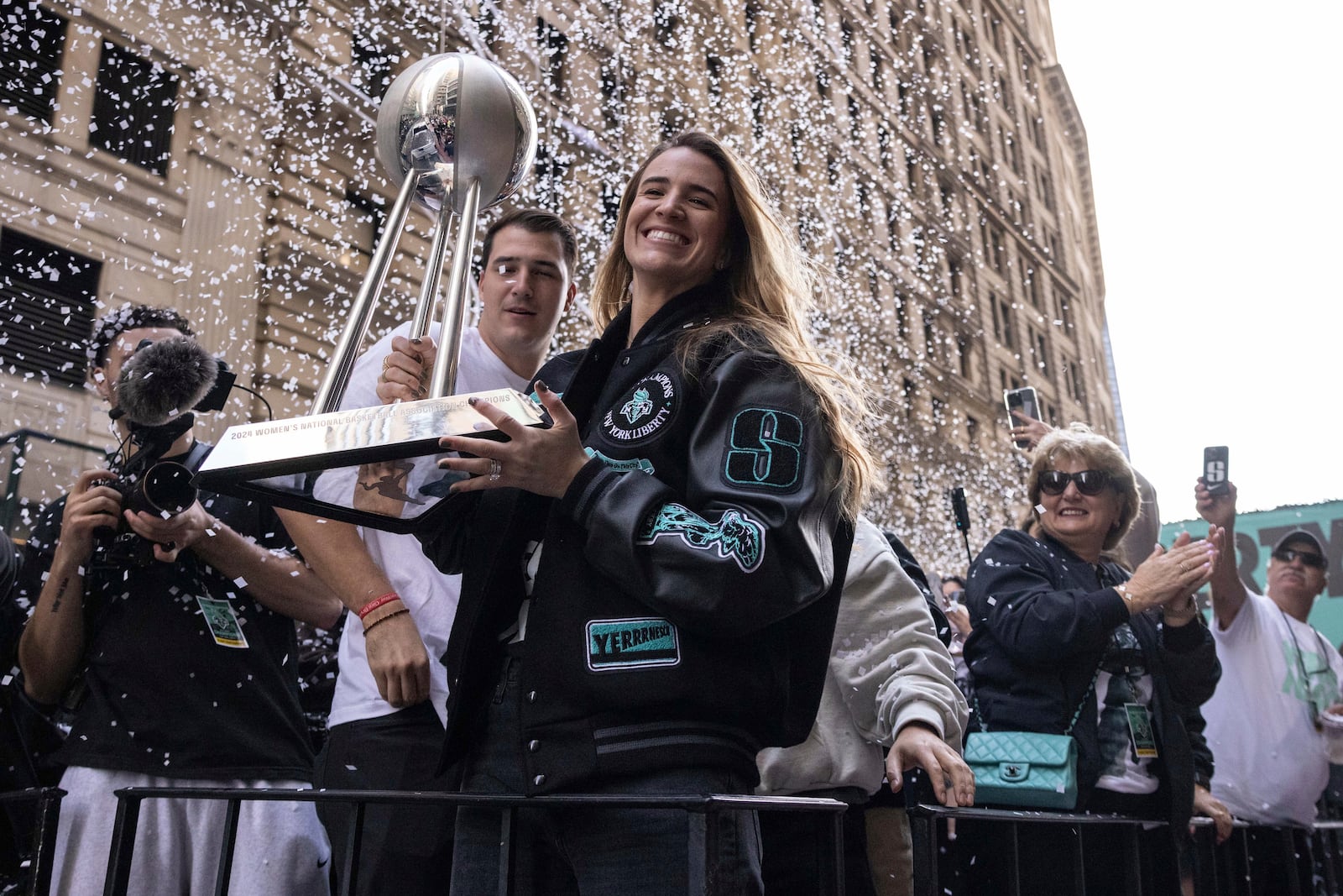 Sabrina Ionescu holds the WNBA basketball championship trophy during the New York Liberty's parade Thursday, Oct. 24, 2024, in New York. (AP Photo/Yuki Iwamura)