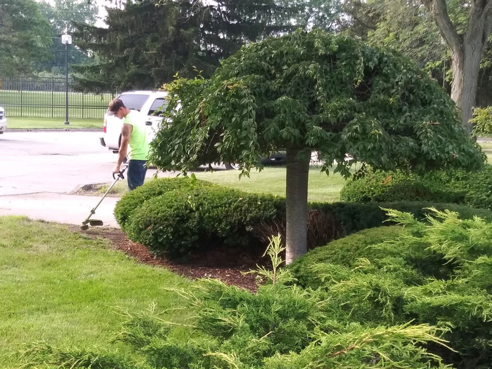 Jordan Dillon, an 88th Civil Engineer Squadron equipment operator, trims weeds and hedges at Air Force Materiel Command headquarters (Bldg. 262) on July 15 as part of his regular weekly duties at Wright-Patterson Air Force Base. CONTRIBUTED PHOTO