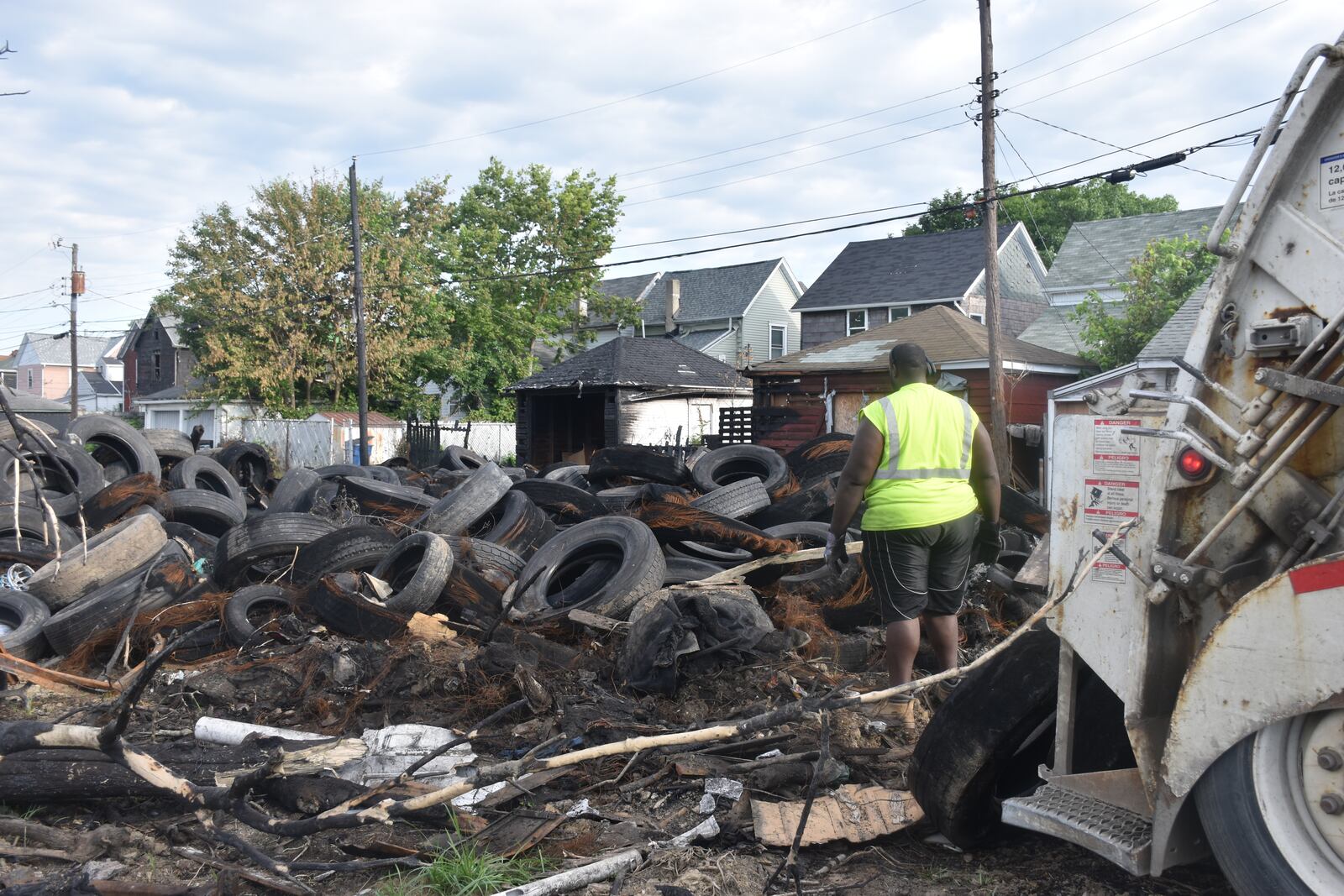 A Rumpke employee helps remove scrap tires on Wednesday, June 12, 2024, on the 1400 block of Leonhard Street. The Ohio EPA is in charge of the cleanup after the tires caught fire in May. CORNELIUS FROLIK / STAFF