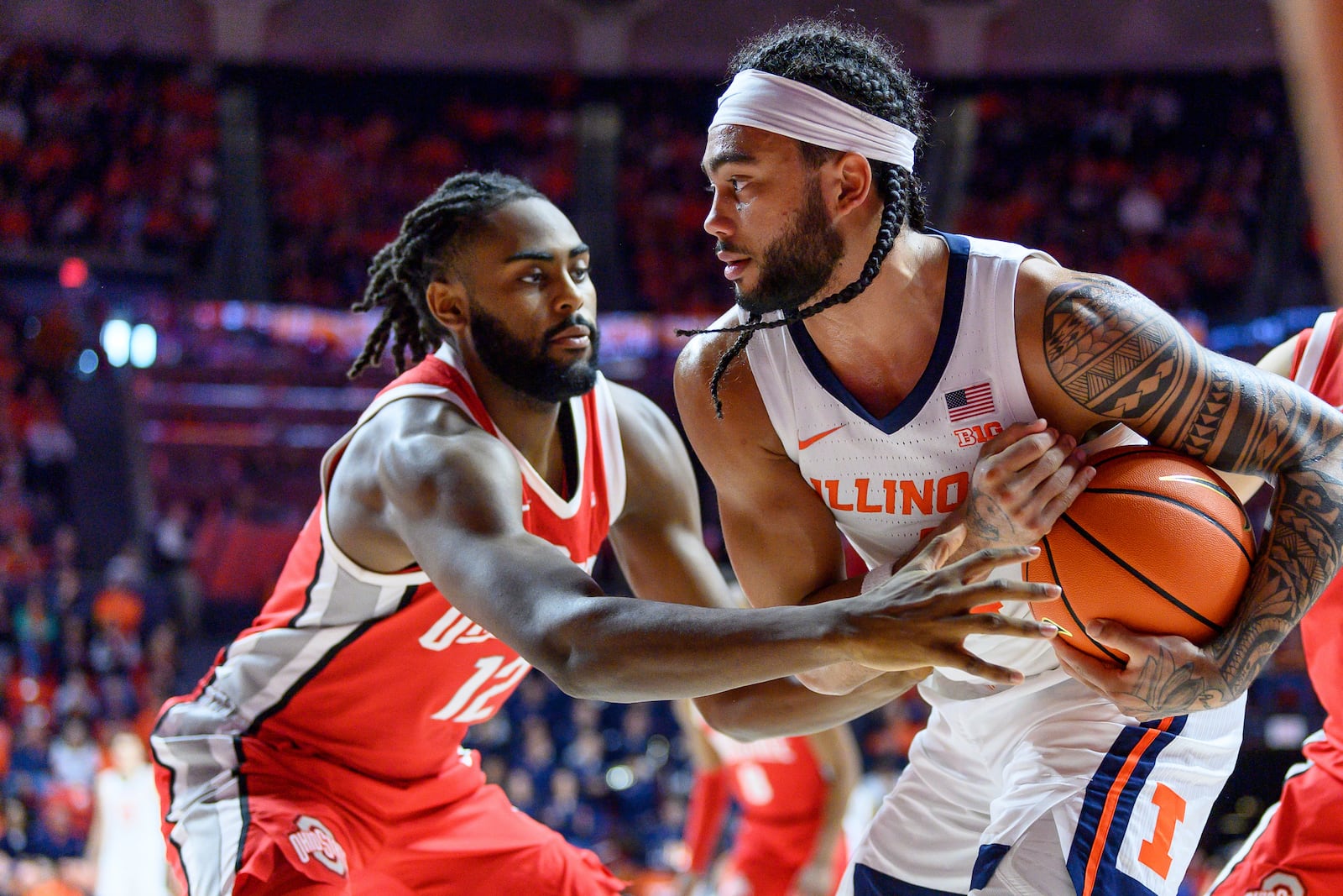 Illinois' Kylan Boswell protects the ball from Ohio State's Evan Mahaffey during the second half of an NCAA college basketball game Sunday, Feb. 2, 2025, in Champaign, Ill. (AP Photo/Craig Pessman)