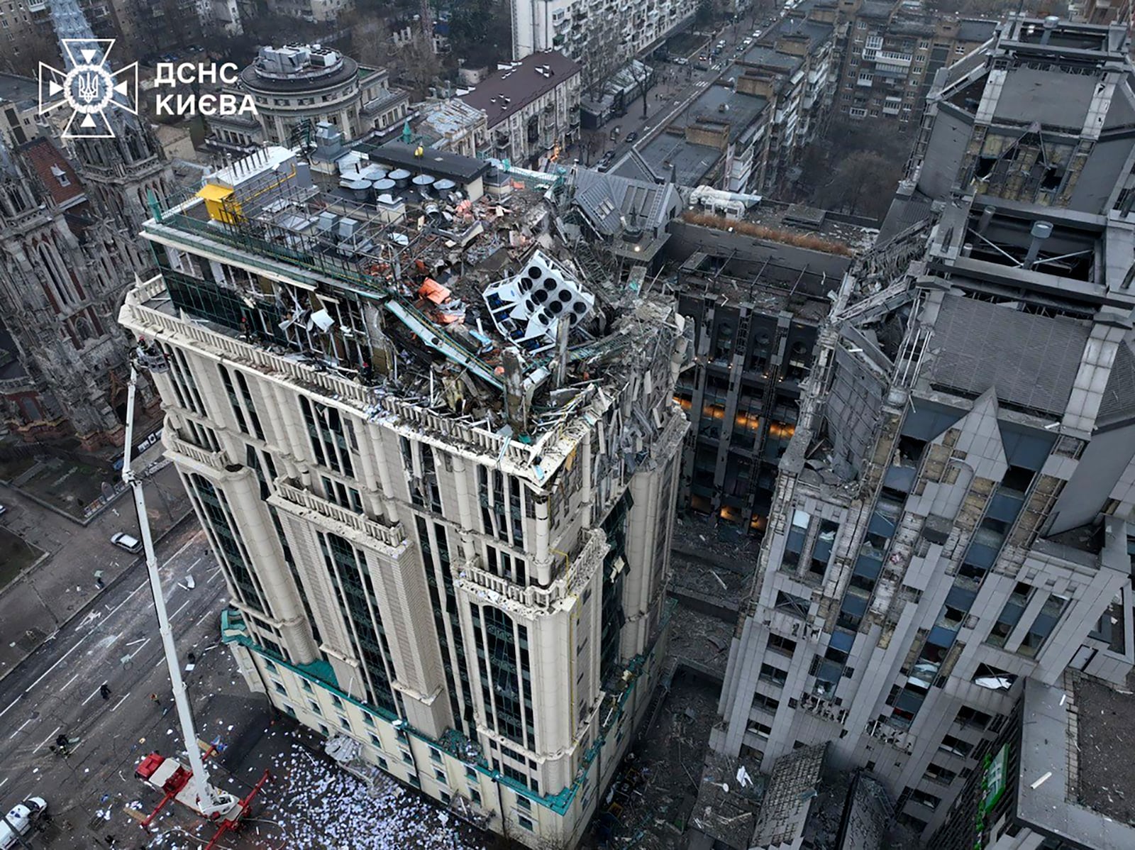 In this photo provided by the Ukrainian Emergency Service, firefighters work on the site of a damaged building after a Russian missile attack in Kyiv, Ukraine, Friday, Dec. 20, 2024. (Ukrainian Emergency Service via AP)