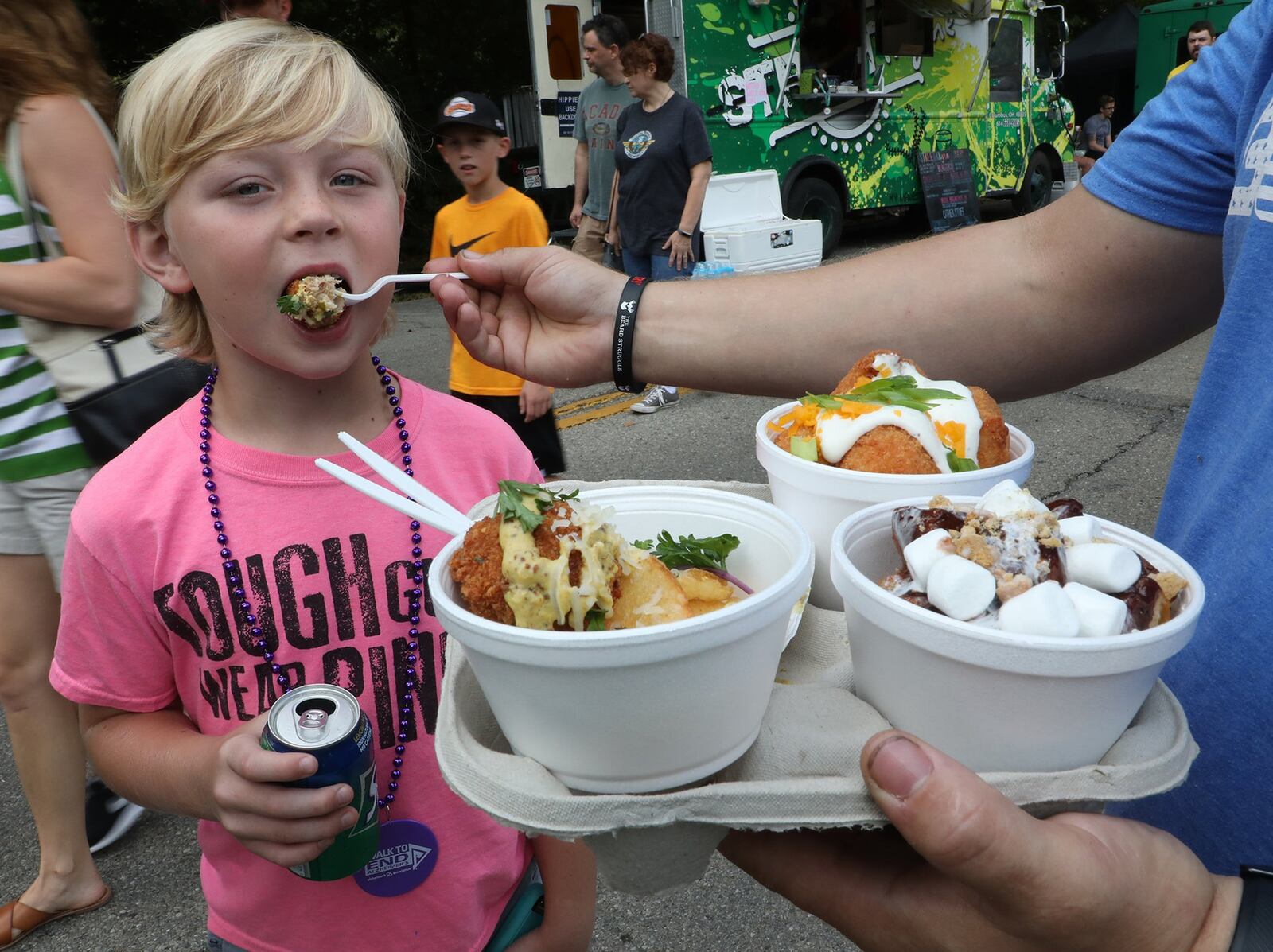 A child enjoys an eclectic assortment of treats served up during the 2018 Springfield Rotary Gourmet Food Truck Competition at Veteran’s Park. BILL LACKEY / STAFF