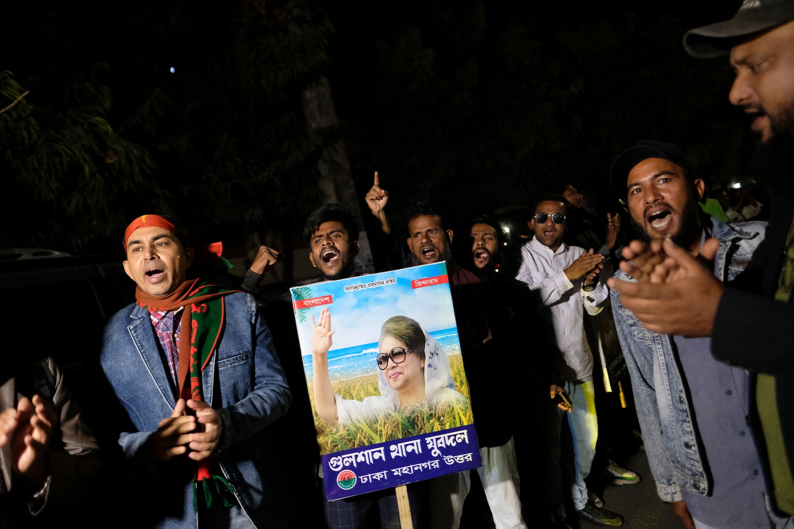 Supporters of Bangladesh's ailing former Prime Minister Khaleda Zia shout slogans before Zia left Dhaka, Bangladesh, to travel to London for medical treatment, Tuesday, Jan. 7, 2025. (AP Photo/Mahmud Hossain Opu)