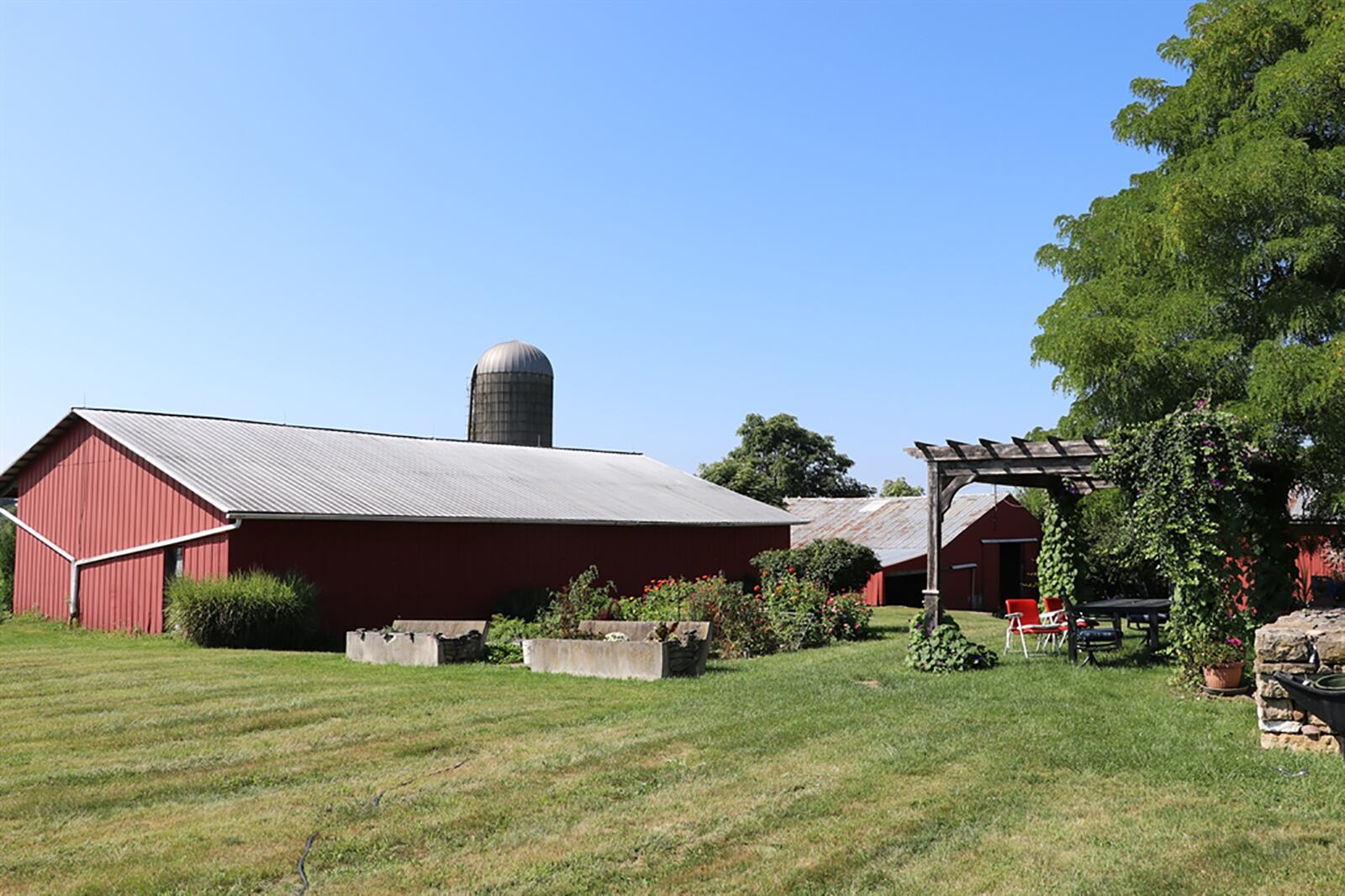 The near 61-acre property includes 2 former dairy barns, a 2-car detached garage with upstairs storage, a springhouse, grain silos and a milk house. CONTRIBUTED PHOTO BY KATHY TYLER