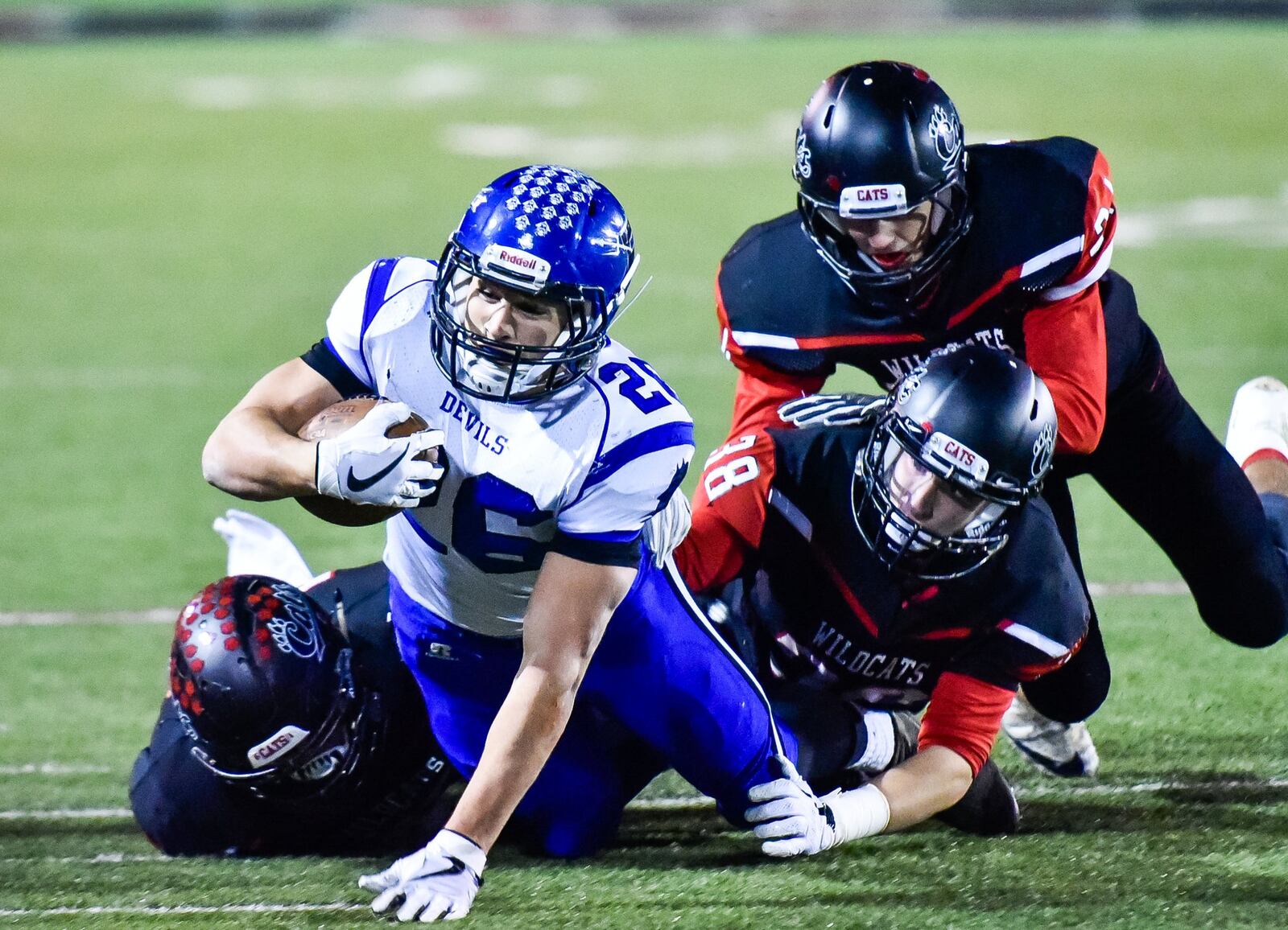 Brookville’s Bailey Wallen tries to get away from a trio of Franklin defenders Thursday night at Atrium Stadium in Franklin. Wallen rushed for 150 yards to bring his season total to a school-record 2,035. NICK GRAHAM/STAFF