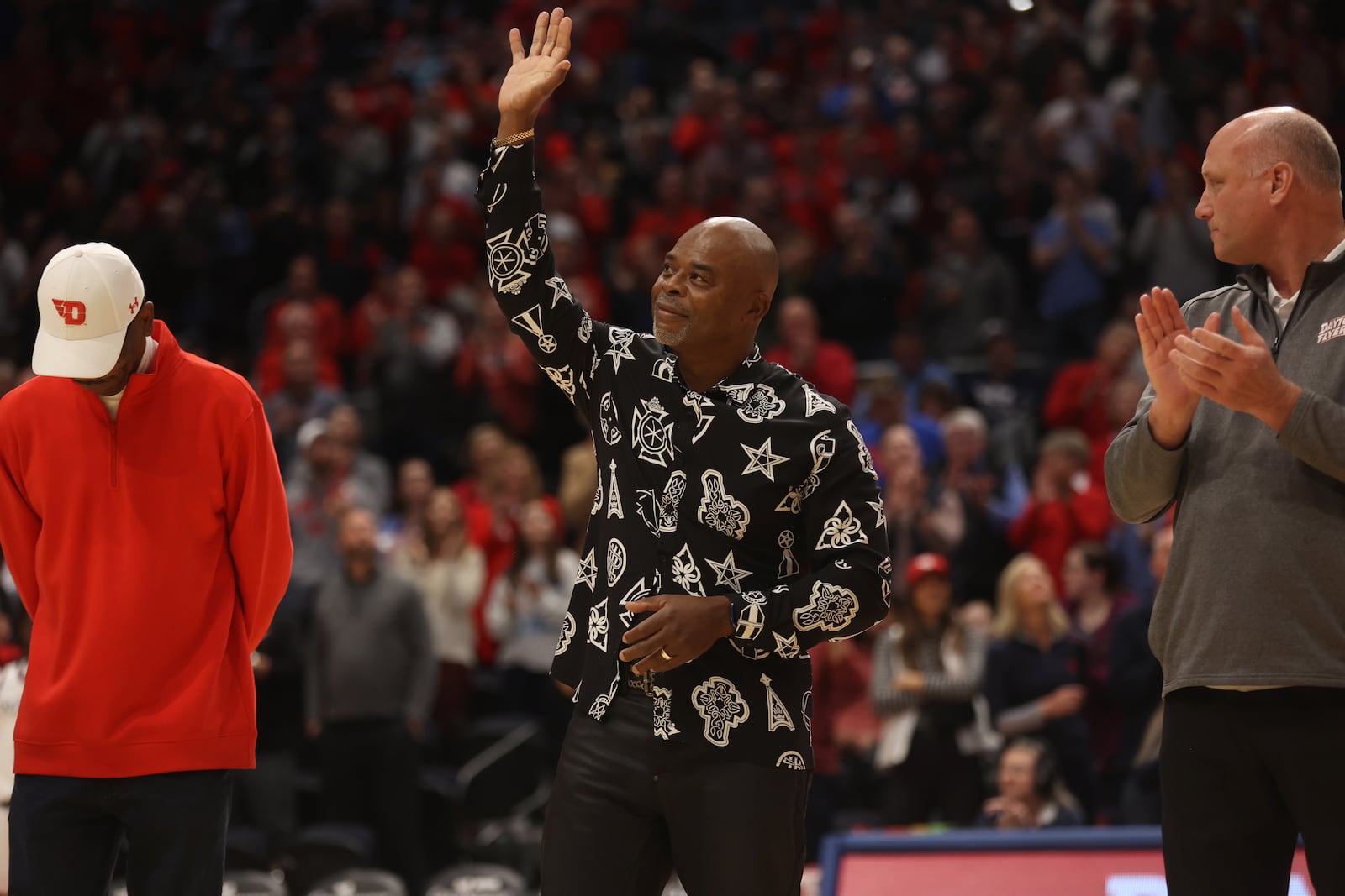 Sedric Toney waves to the crowd during a ceremony honoring members of Dayton's 1984 Elite Eight team at halftime of a game against Grambling State on Saturday, Dec. 2, 2023, at UD Arena. David Jablonski/Staff