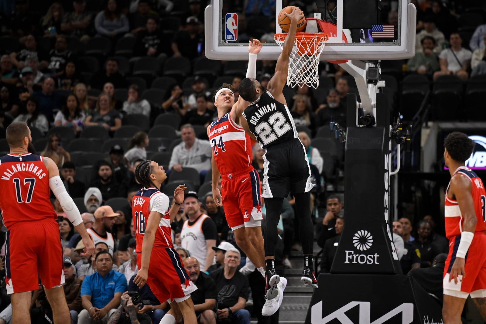 San Antonio Spurs' Malaki Branham (22) dunks against Washington Wizards' Corey Kispert (24) during the first half of an NBA basketball game, Thursday, Nov. 13, 2024, in San Antonio. (AP Photo/Darren Abate)