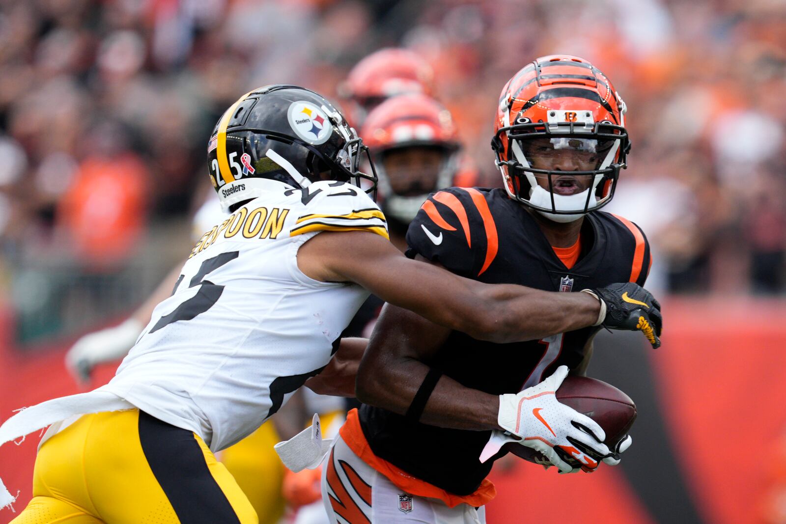 Cincinnati Bengals wide receiver Ja'Marr Chase (1) runs against Pittsburgh Steelers cornerback Ahkello Witherspoon (25) during the second half of an NFL football game, Sunday, Sept. 11, 2022, in Cincinnati. (AP Photo/Jeff Dean)