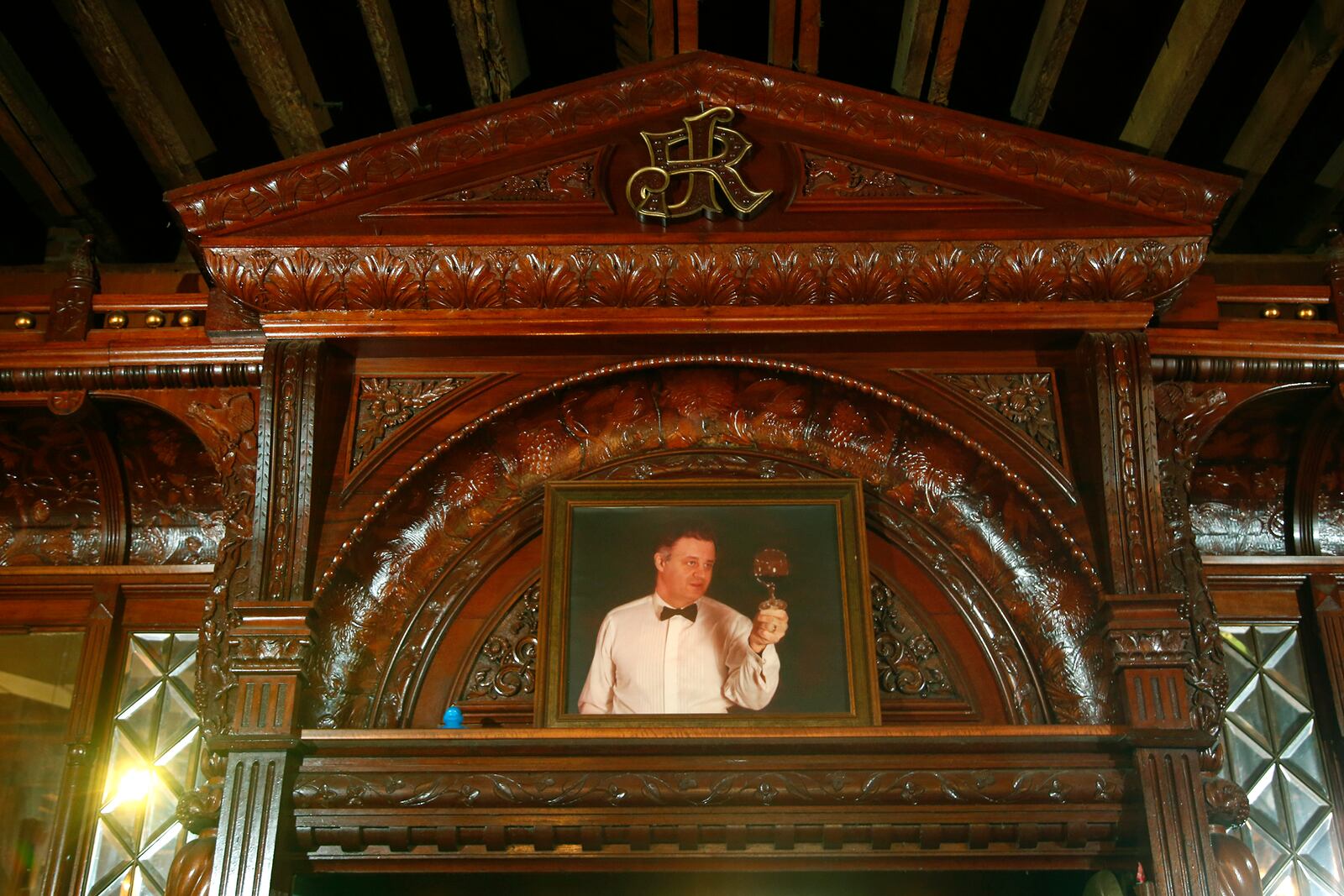 James Rittys initials are intertwined at the peak of the historic bar at Jay's Restaurant. Today, a painting of Jay Haverstick, who died in 2009, rests below them.  LISA POWELL / STAFF