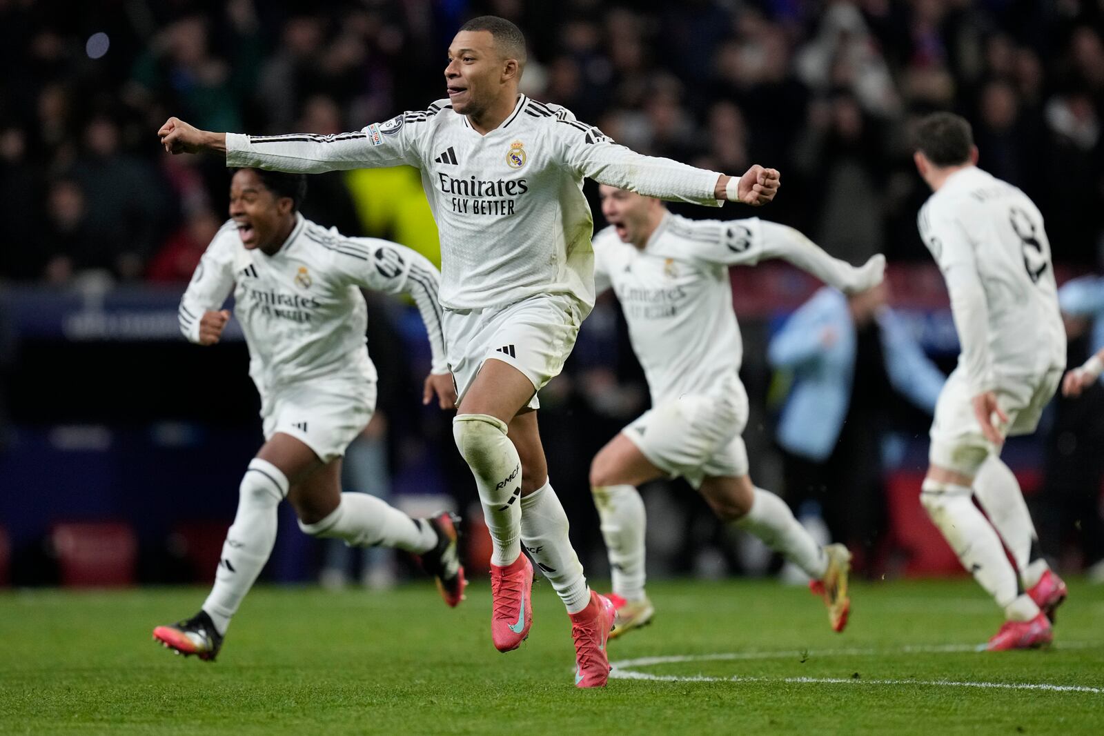 Real Madrid's Kylian Mbappe celebrates after winning the penalty shootout during the Champions League round of 16, second leg, soccer match between Atletico Madrid and Real Madrid at the Metropolitano stadium in Madrid, Spain, Wednesday, March 12, 2025. (AP Photo/Bernat Armangue)