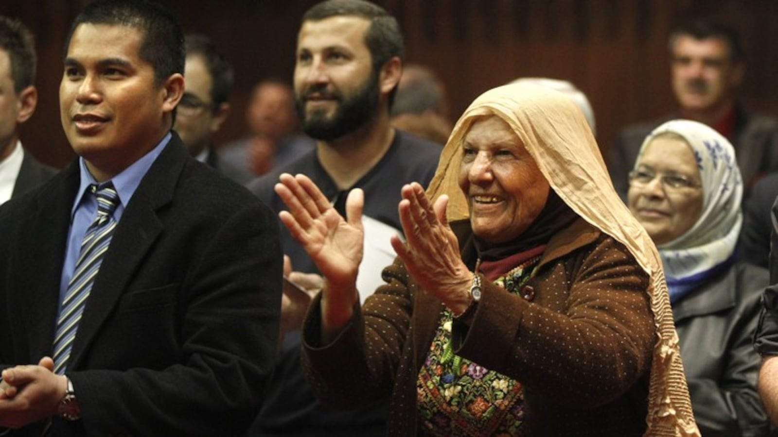 Bernie Tolitol, who is from the Phillipines, (left) and Mariam Mirib, who is from Palestine, celebrate with others who took part in a naturalization ceremony in Dayton three years ago. LISA POWELL / STAFF