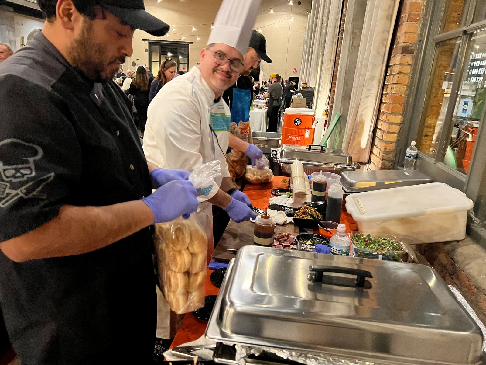 Chef Adrian from Loose Ends Brewing smiles as he plates at Sneak Peek to Winter Restaurant Week. 