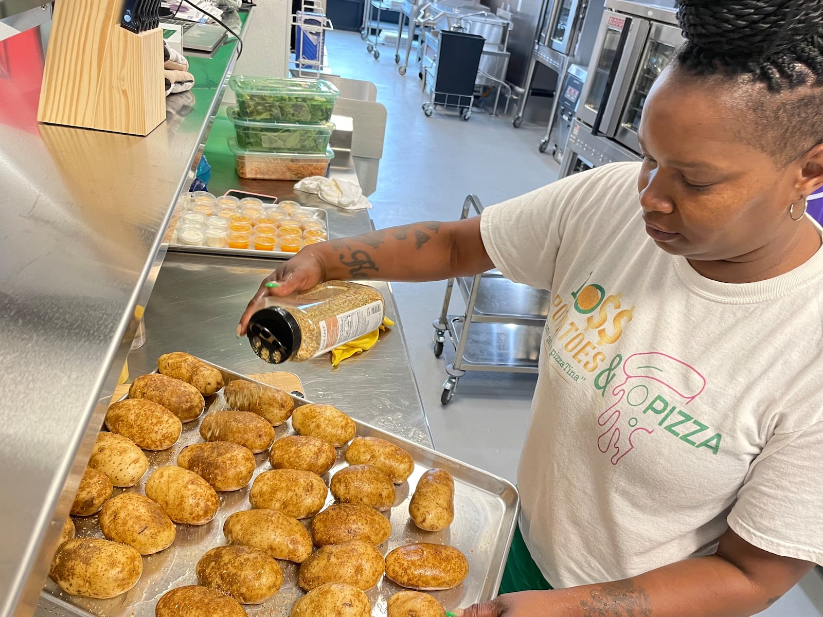 Dayton native Martina Scott, owner of Boss Potatoes, has quadrupled her customer base since she started cooking from her home almost four years ago. On Wednesday, Aug. 7 she started her first day as a member of 6888 Kitchen Incubator at the Dayton Arcade. NATALIE JONES/STAFF