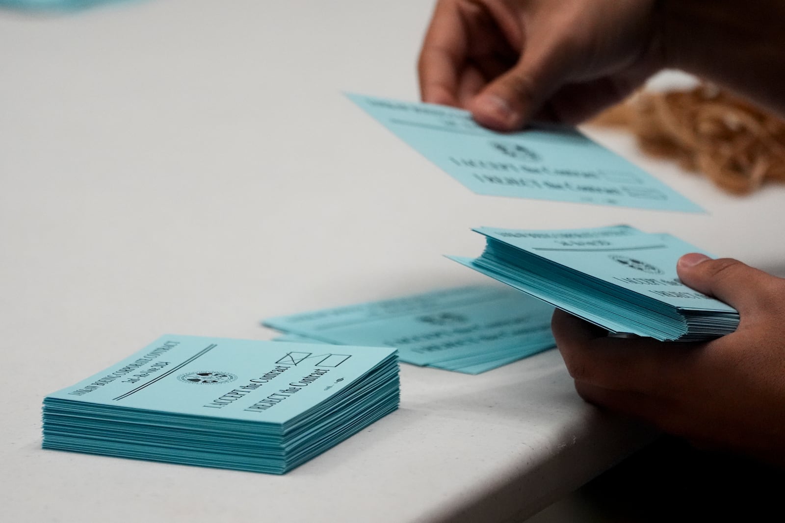 A volunteer sorts votes on a new contract offer from Boeing, Monday, Nov. 4, 2024, at the IAM District 751 Union Hall in Seattle. (AP Photo/Lindsey Wasson)