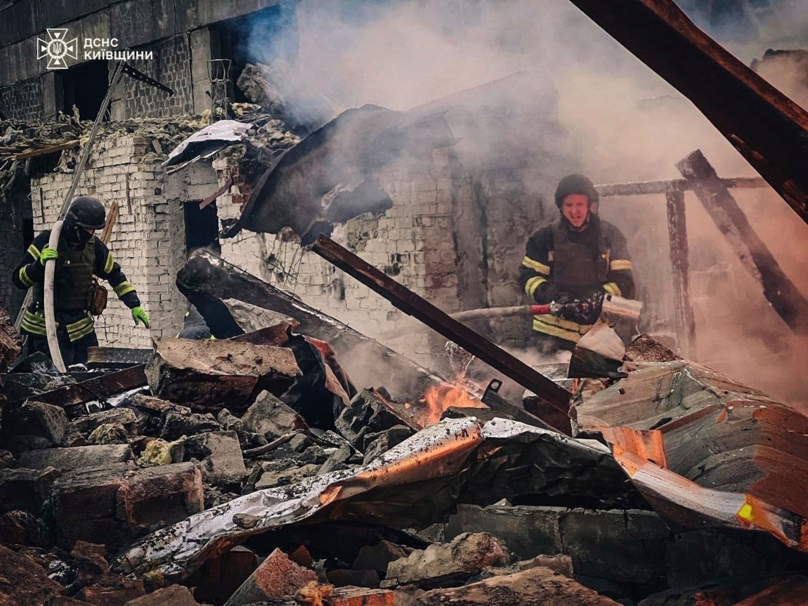 In this photo provided by the Ukrainian Emergency Service on Nov. 13, 2024, rescue workers extinguish a fire of a building destroyed by a Russian strike in Brovary, outside Kyiv, Ukraine. (Ukrainian Emergency Service via AP)