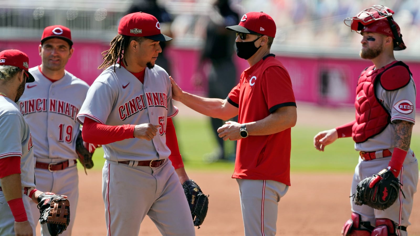 Cincinnati Reds starting pitcher Luis Castillo, center left, is relieved by manager David Bell during the sixth inning against the Atlanta Braves in Game 2 of a National League wild-card baseball series, Thursday, Oct. 1, 2020, in Atlanta. (AP Photo/John Bazemore)