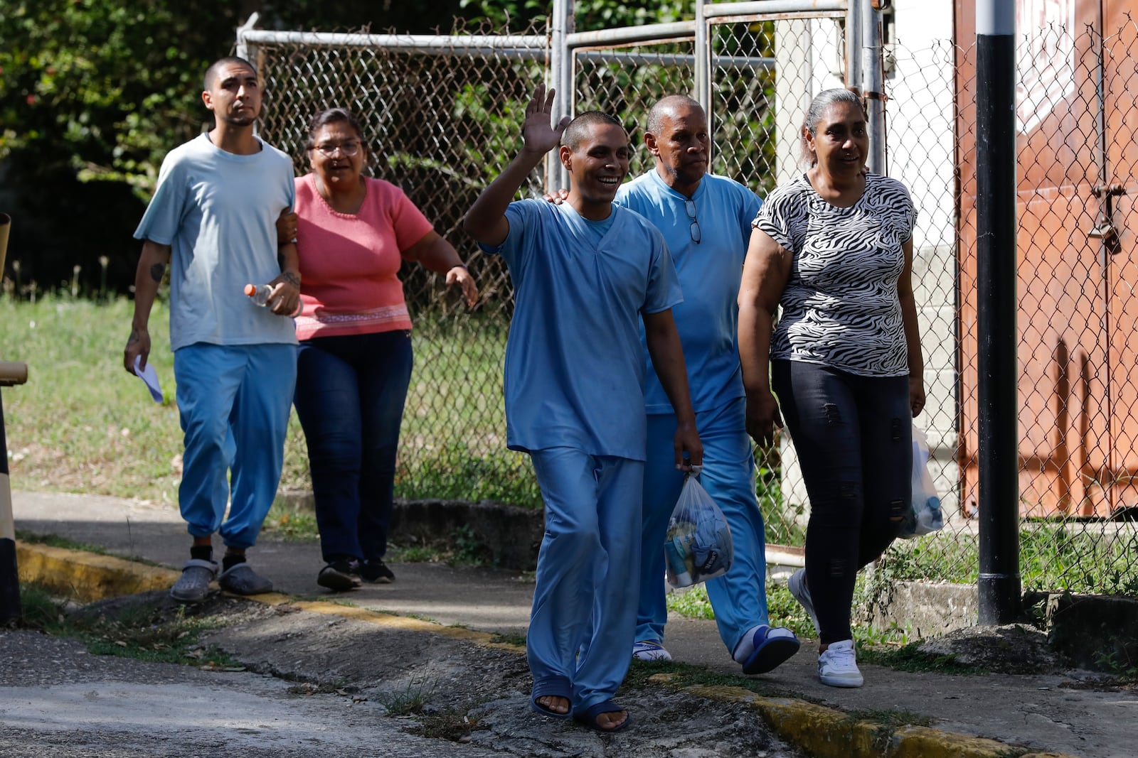 People detained during a government crackdown following anti-government protests against the results of the presidential election, walk out of the Yare 3 prison in San Francisco de Yare, Venezuela, Saturday, Nov. 16, 2024. (AP Photo/Cristian Hernandez)