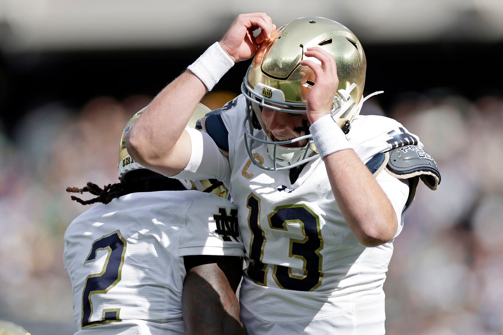 Notre Dame quarterback Riley Leonard (13) celebrates after scoring a touchdown during the first half of an NCAA college football game against Navy Saturday, Oct. 26, 2024, in East Rutherford, N.J. (AP Photo/Adam Hunger)