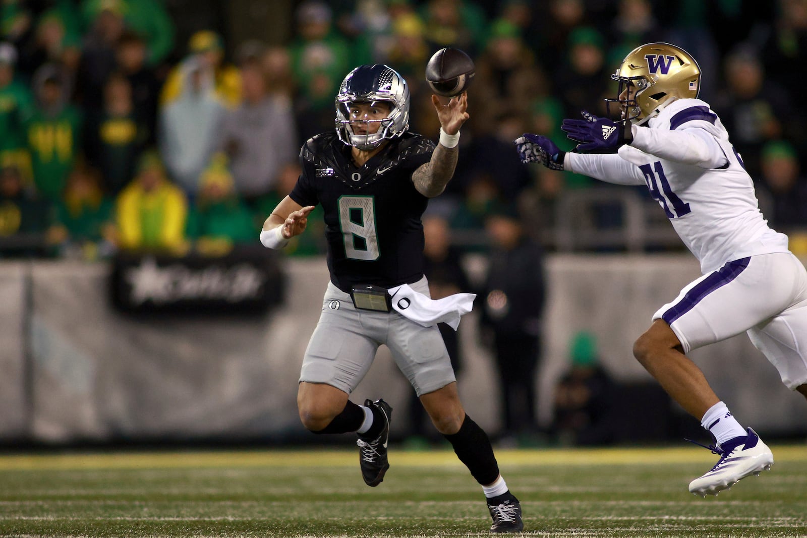 Oregon quarterback Dillon Gabriel (8) shoots off a pass during an NCAA college football game against Washington, Saturday, Nov. 30, 2024, in Eugene, Ore. (AP Photo/Lydia Ely)