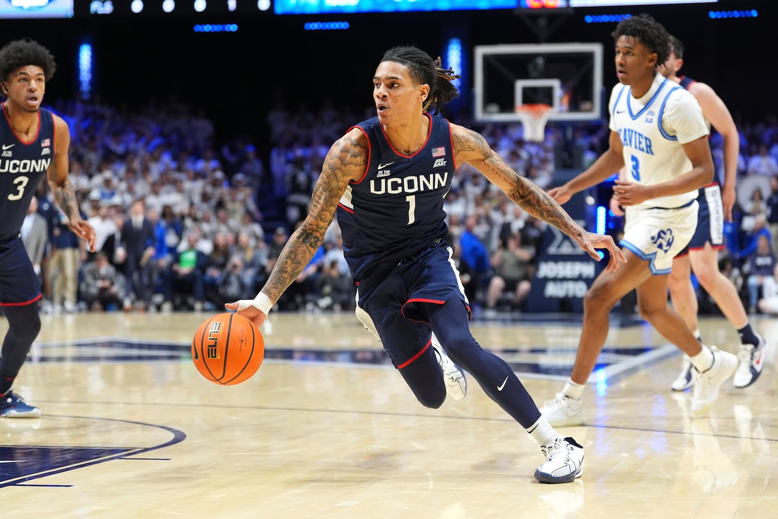 UConn's Solo Ball drives to the basket during the first half of an NCAA college basketball game against Xavier, Saturday, Jan. 25, 2025, Cincinnati. (AP Photo/Kareem Elgazzar)