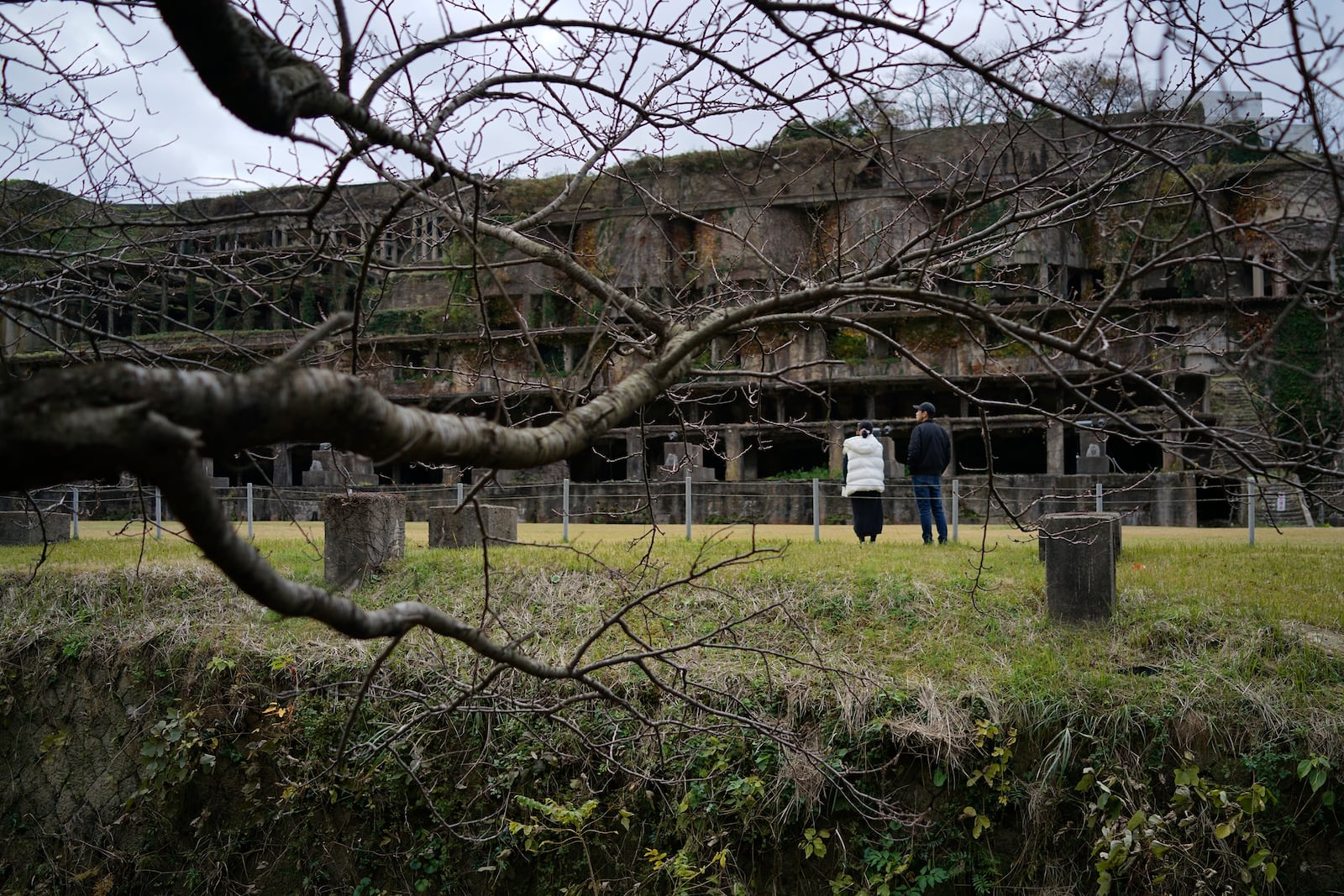 Visitors stroll one of the industrial heritages Kitazawa Flotation Plant, a processing gold ore plant in Sado, Niigata prefecture, Japan Sunday, Nov. 24, 2024. (AP Photo/Eugene Hoshiko)