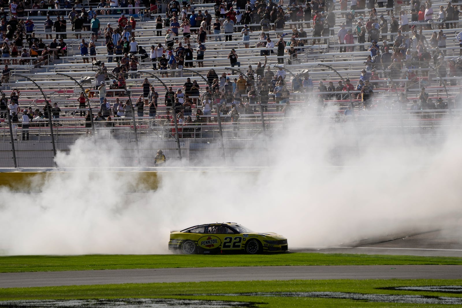 NASCAR Cup Series driver Joey Logano (22) does a burnout after winning a NASCAR Cup Series auto race Sunday, Oct. 20, 2024, in Las Vegas. (AP Photo/John Locher)