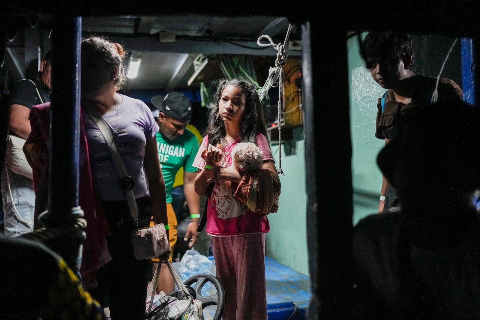 Venezuelan migrant Davinny Moreno boards a boat with her mother Eva Ramirez, left, to depart from the Caribbean coastal village of Miramar, Panama, for the Colombian border, Thursday, Feb. 27, 2025, as migrants return from southern Mexico after abandoning hopes of reaching the U.S. in a reverse flow triggered by the Trump administration's immigration crackdown. (AP Photo/Matias Delacroix)