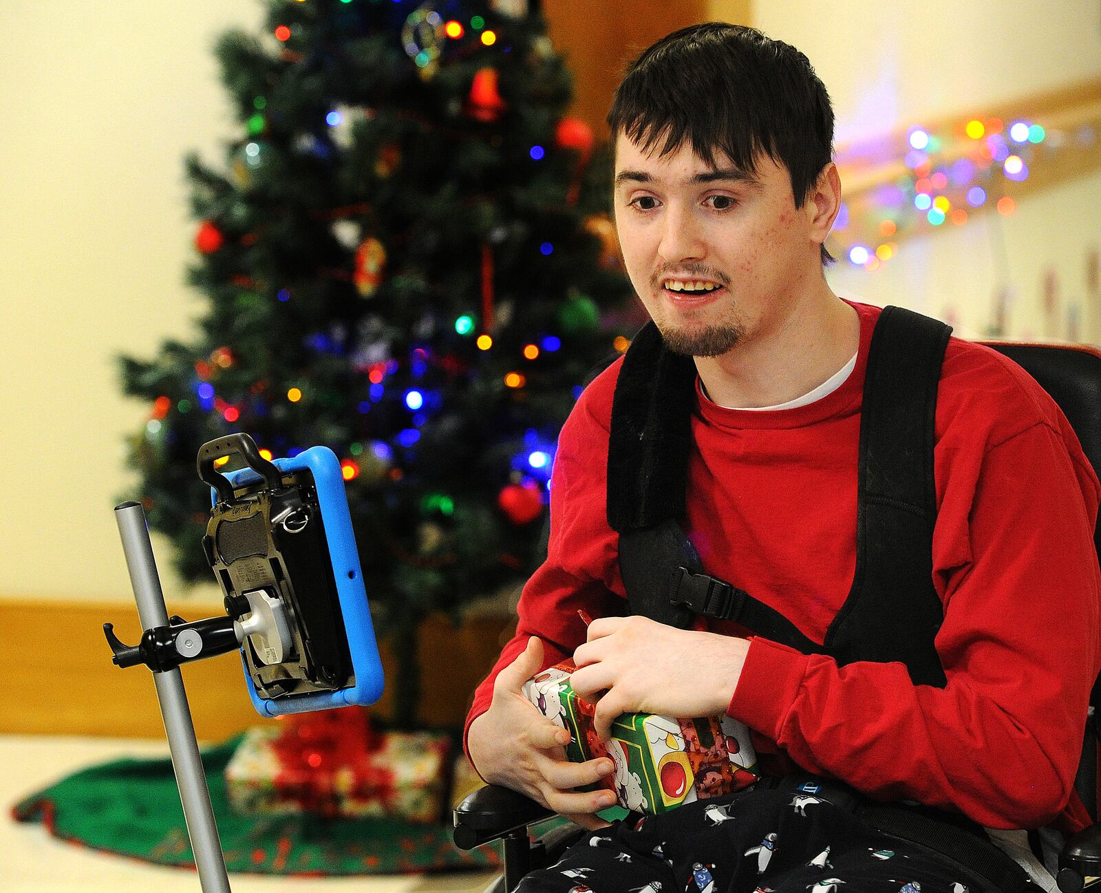 Stephen L., 23, a resident at Stillwater Center in Clayton, opens a flying spinner as a part of his haul of Christmas gifts on Tuesday, Dec. 19, 2023. MARSHALL GORBY\STAFF