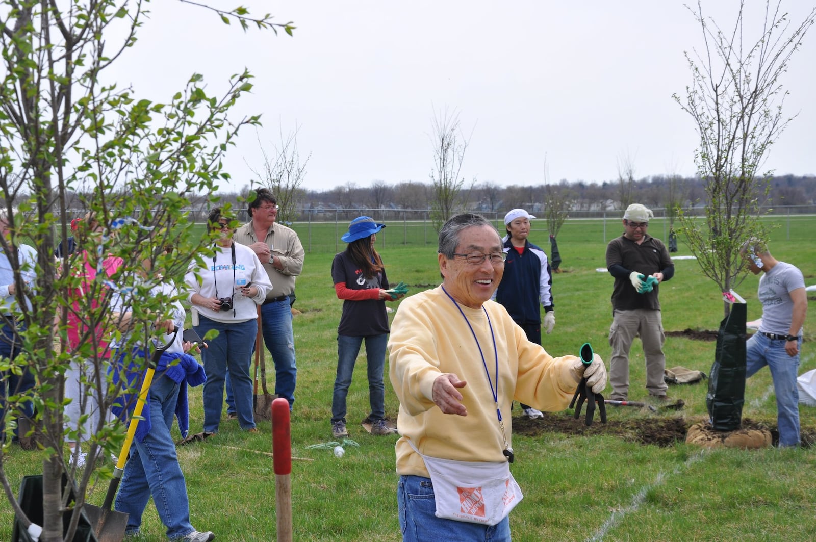 Dayton Foundation donor Alex Hara (center) helps plant cherry trees as a thank you to the Dayton community. CONTRIBUTED