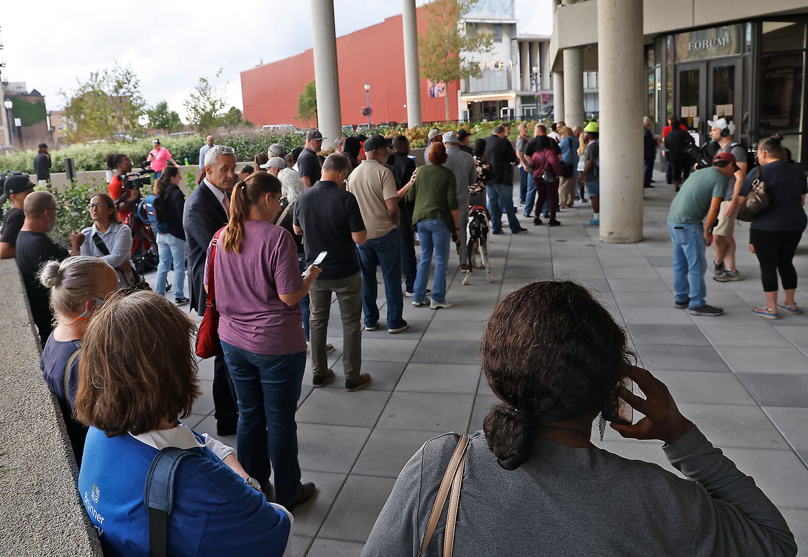 People wait outside the Springfield City Hall Forum as they wait to be let in for the City Commission meeting Tuesday, Sept. 24, 2024. BILL LACKEY/STAFF