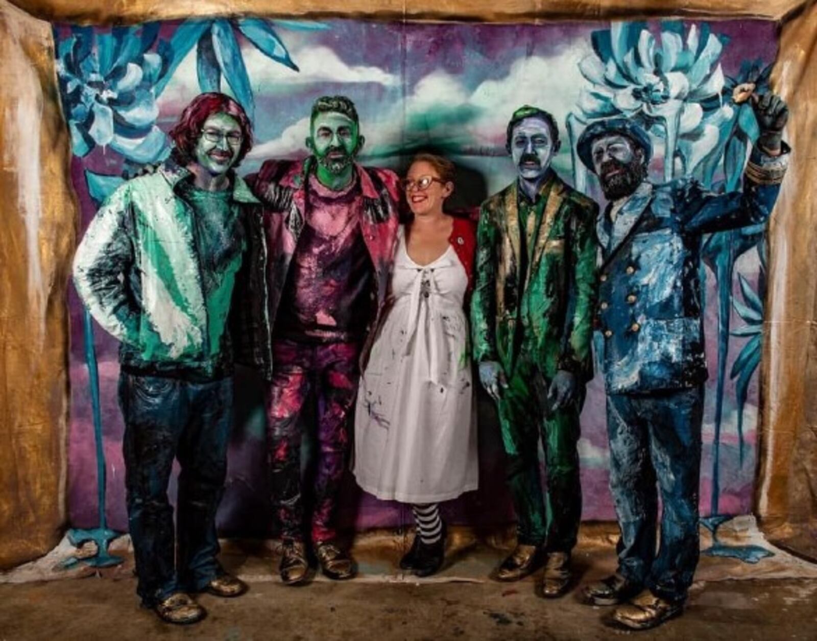 Dayton band Yuppie poses with the Mural Machine's Tiffany Clark, who assisted with the art in their first music video for "A Place to Call My Own."