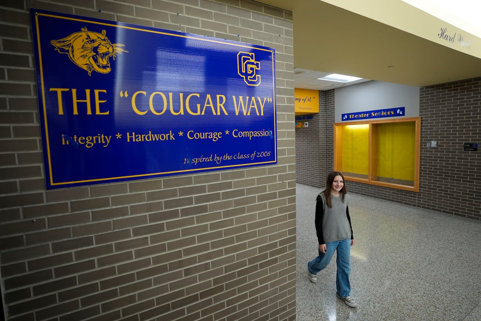 Makenzie Gilkison walks down the hallway at Greenfield Central High School, Tuesday, Dec. 17, 2024, in Greenfield, Ind. (AP Photo/Darron Cummings)