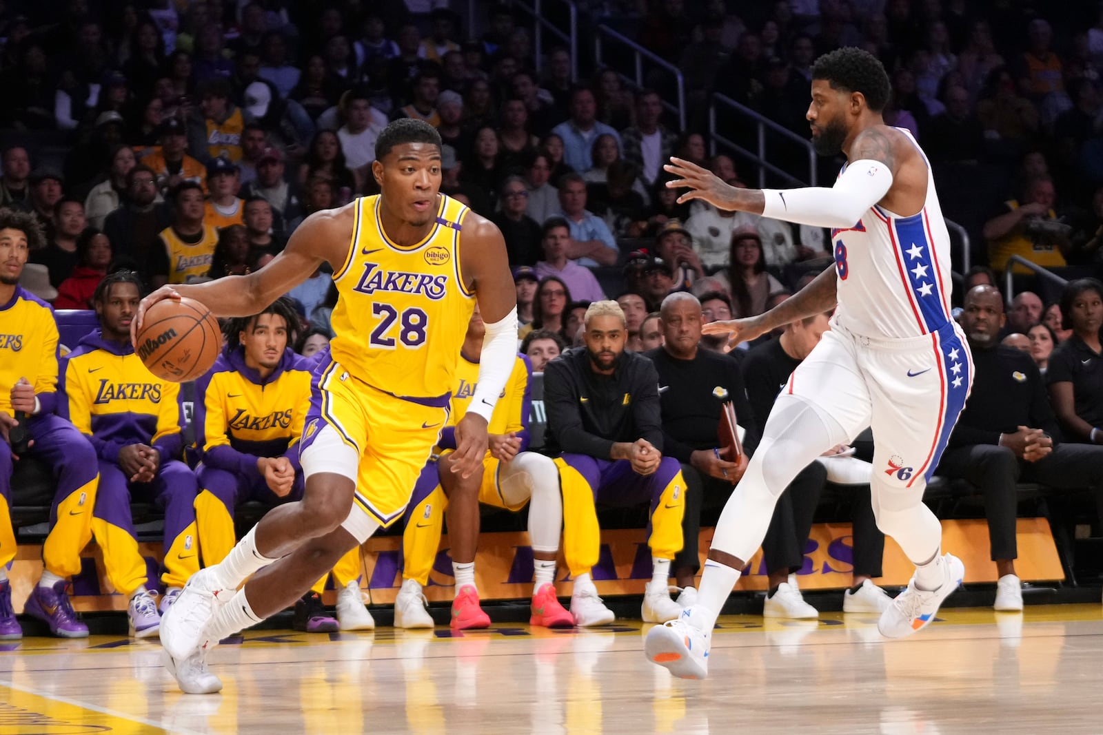 Los Angeles Lakers forward Rui Hachimura, left, tires to drive past Philadelphia 76ers forward Paul George during the first half of an NBA basketball game, Friday, Nov. 8, 2024, in Los Angeles. (AP Photo/Mark J. Terrill)