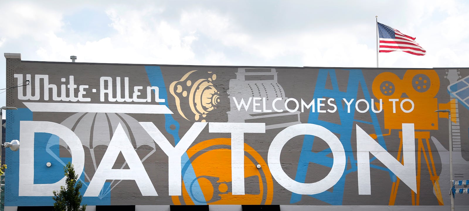 Welcoming commuters to Dayton is a mural spanning the length of the White Allen body shop, 442 N. Main Street. The artwork, a collaboration with local artist Amy Deal and K12 Gallery & TEJAS, celebrates the innovative history of the city. LISA POWELL / STAFF