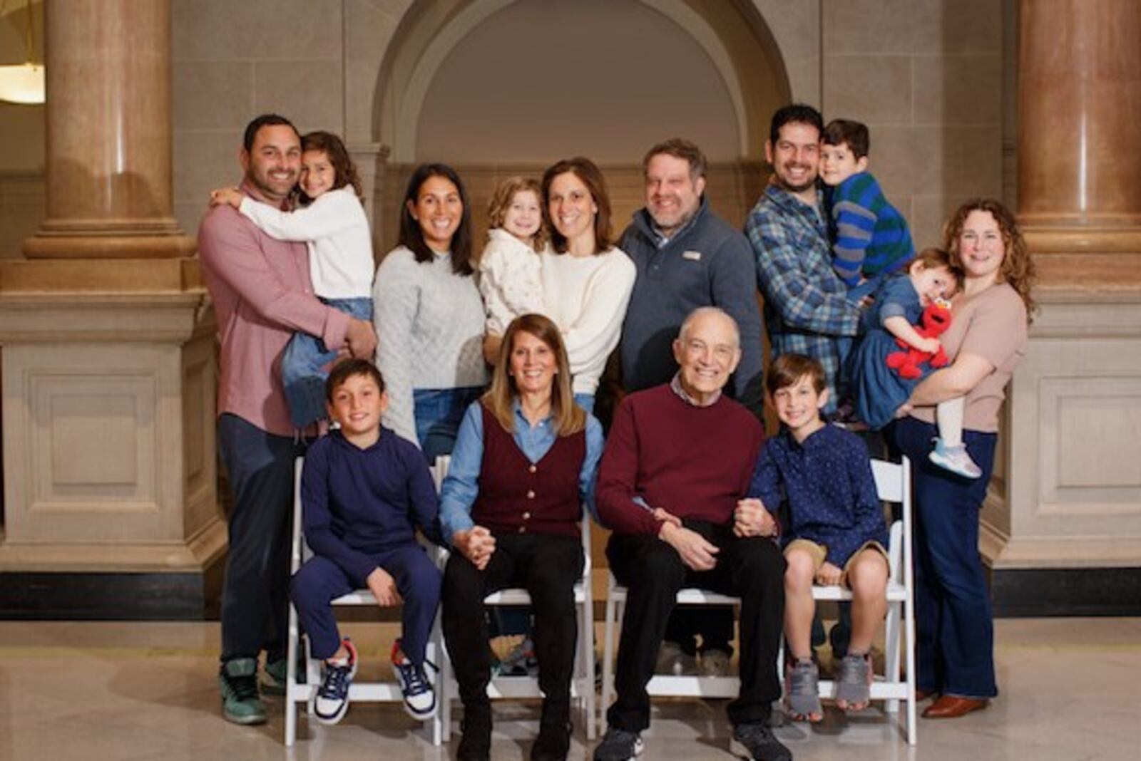 Marc Katz and wife Julie with their family. Joining them up front are grandson Jonah Waitz (left) and Noah Storchan (right). Back row (left to right): son-in-law Michael Waitz holding his daughter/ their granddaughter Emma; daughter Aviva Waitz; daughter Rachel Katz and her son/their grandson Ethan; Rachel’s husband Geoff Storchan; son Alex Katz holding his son/their grandson Rami; and his wife Elena Mayer holding daughter/granddaughter Maya. CONTRIBUTED