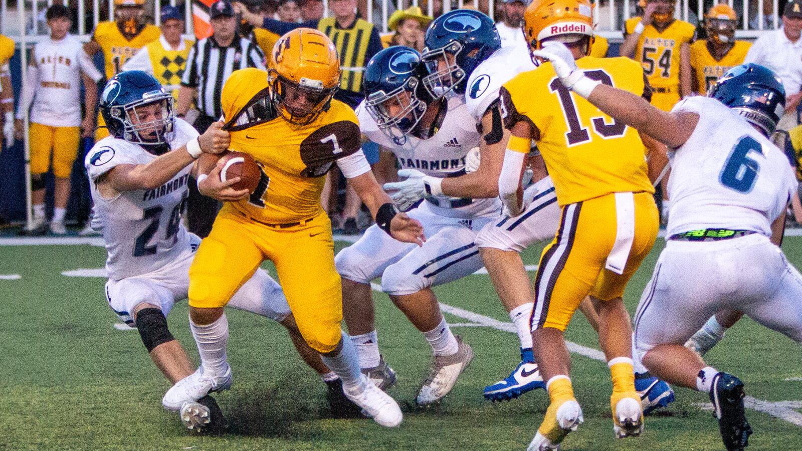 Alter quarterback Gavin Connor is pulled down by Fairmont's Logan Wilkins during Thursday night's 24-7 Fairmont victory. Jeff Gilbert/CONTRIBUTED