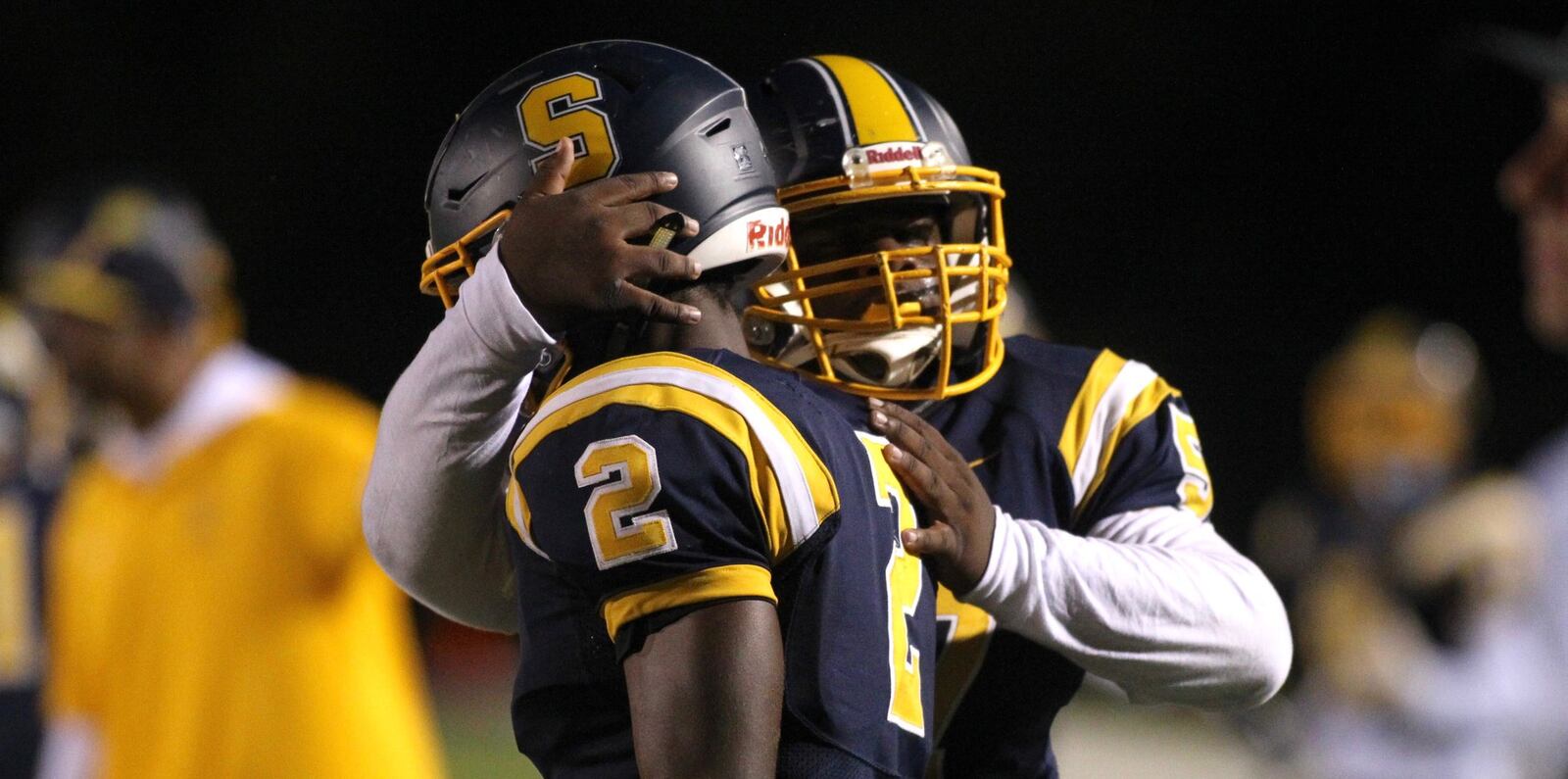 Springfield’s Jokell Brown, back, hugs Moses Douglass after a touchdown against Xenia on Friday, Sept. 28, 2018, at Evans Stadium in Springfield. David Jablonski/Staff