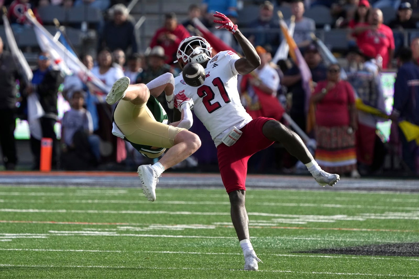 Miami (Ohio) defensive back Toney Coleman Jr. (21) knocks the ball away from Colorado State wide receiver Dane Olson, left, in the first half of the Arizona Bowl NCAA college football game, Saturday, Dec. 28, 2024, in Tucson, Ariz. (AP Photo/Rick Scuteri)