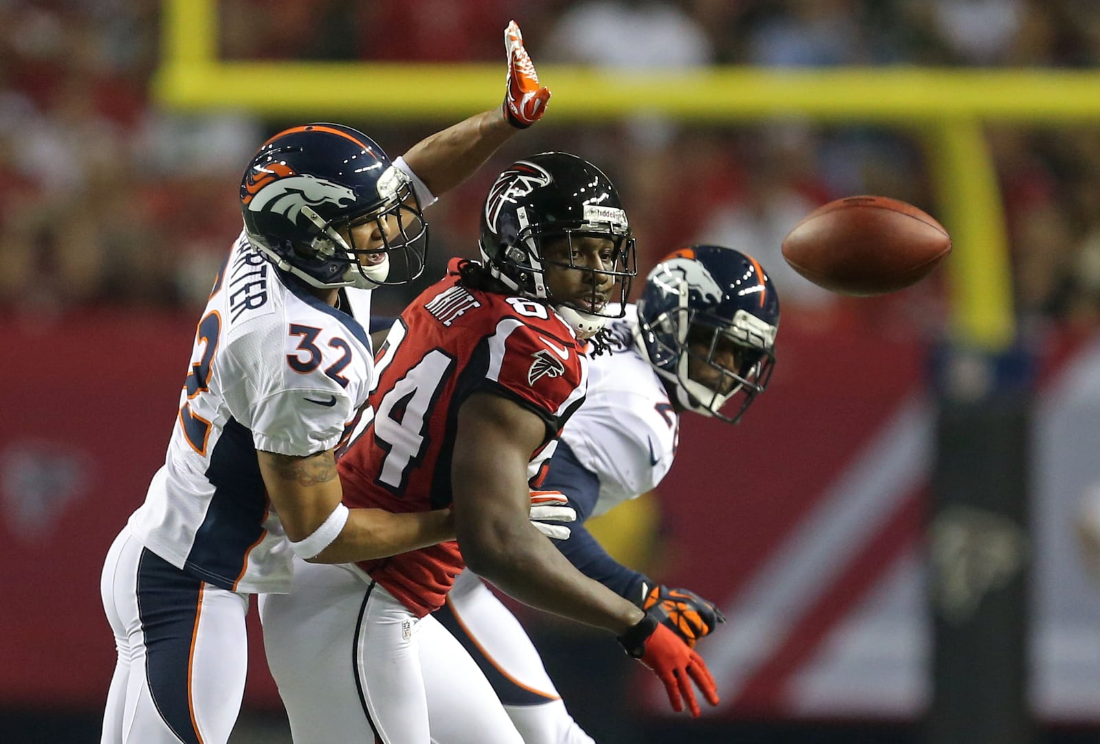 September 17, 2012 - Atlanta, Ga.,: Atlanta Falcons wide receiver Roddy White, center, watches as a pass is deflected by Denver Broncos cornerback Tony Carter, left, in the first half of their game against the Denver Broncos in the Georgia Dome Monday night in Atlanta, Ga., September 17, 2012. JASON GETZ / Atlanta Journal Constitution