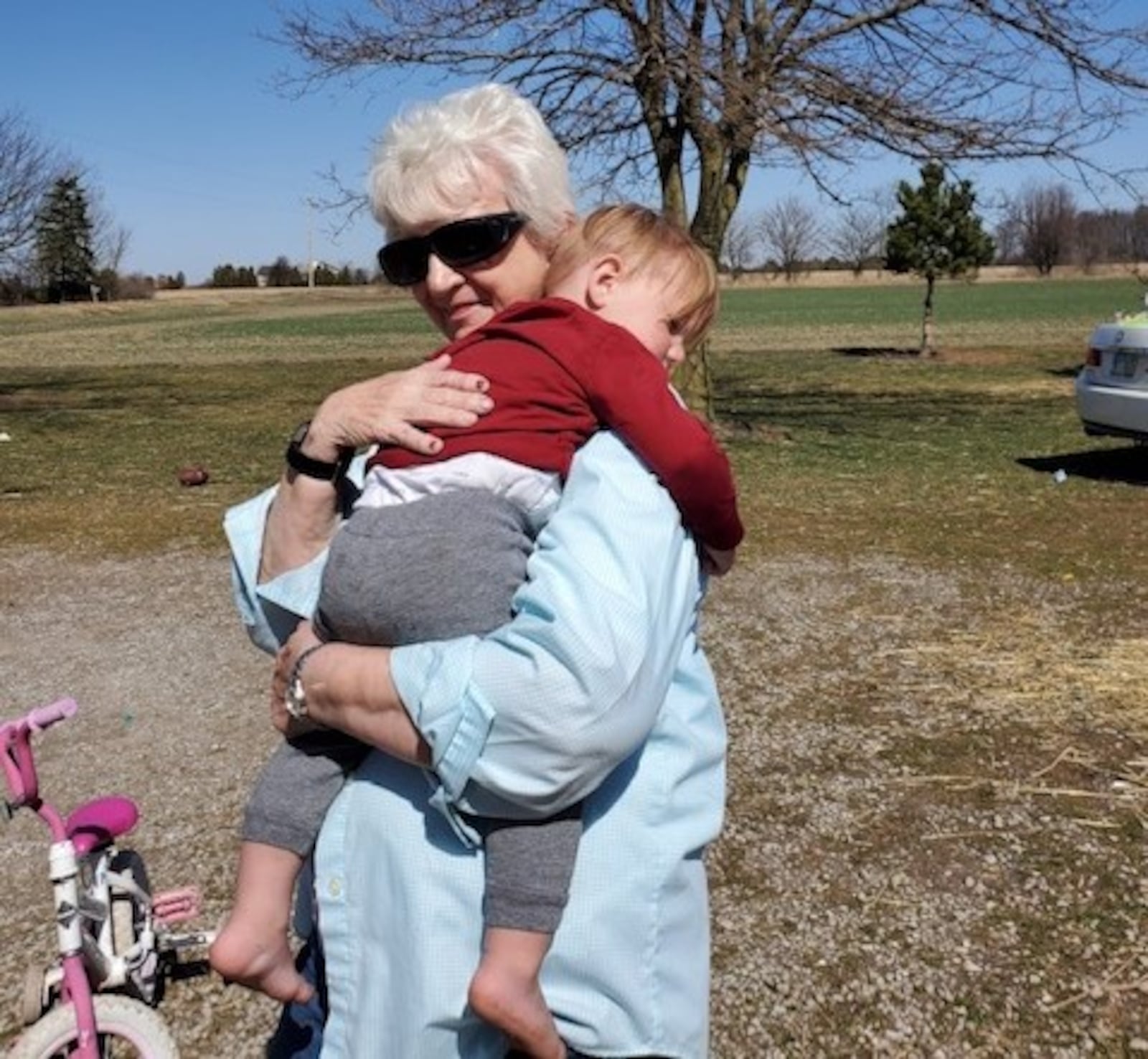 Marie Trittschuh hugs her 2-year-old great-grandson Harper Kosicki last weekend. They haven't seen each other throughout the pandemic except for the two funerals of Trittschuh's children, Harper's grandma and great-uncle, who died from COVID-19. 