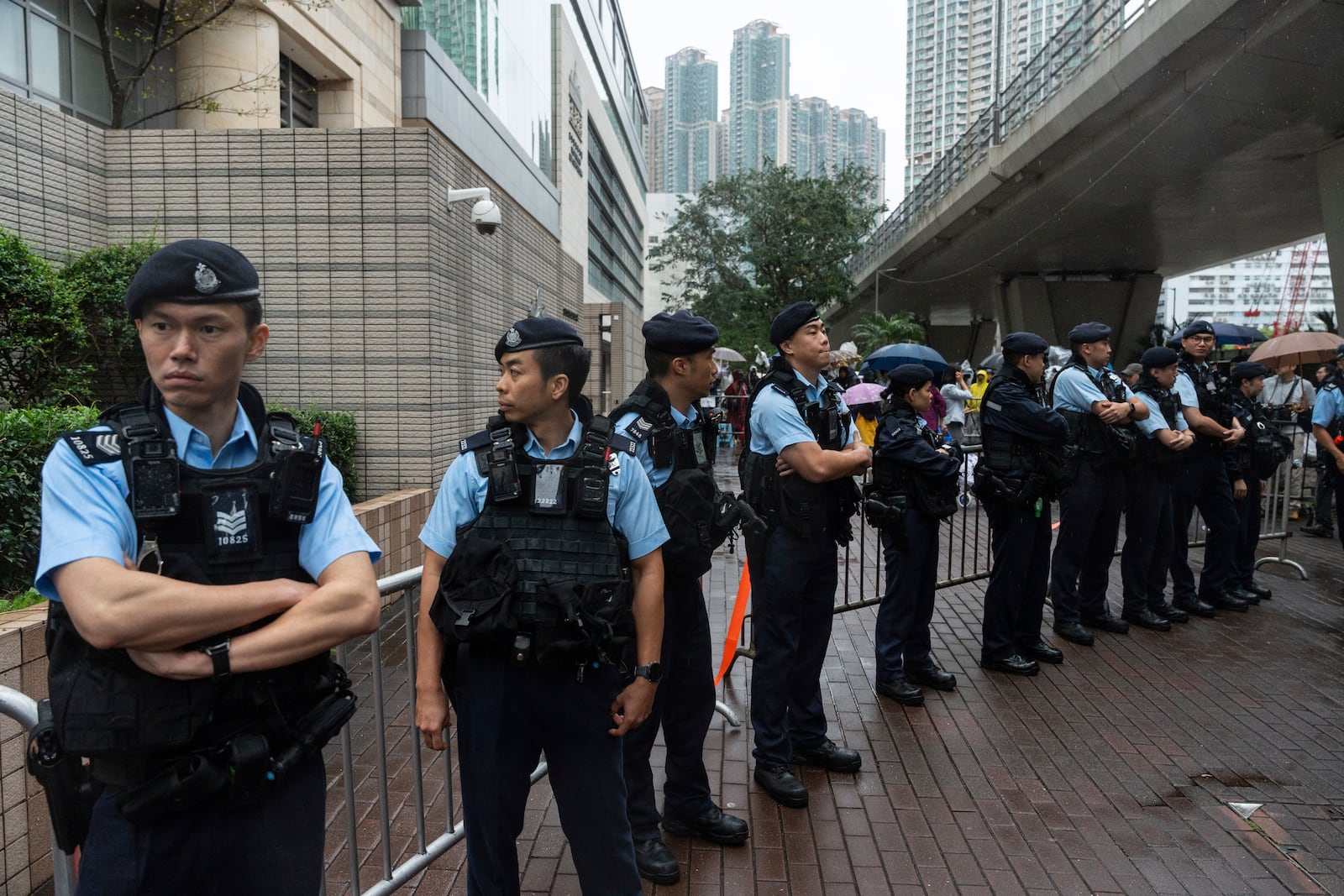 Police officers stand guard outside the West Kowloon Magistrates' Courts in Hong Kong, Tuesday, Nov. 19, 2024. (AP Photo/Chan Long Hei)