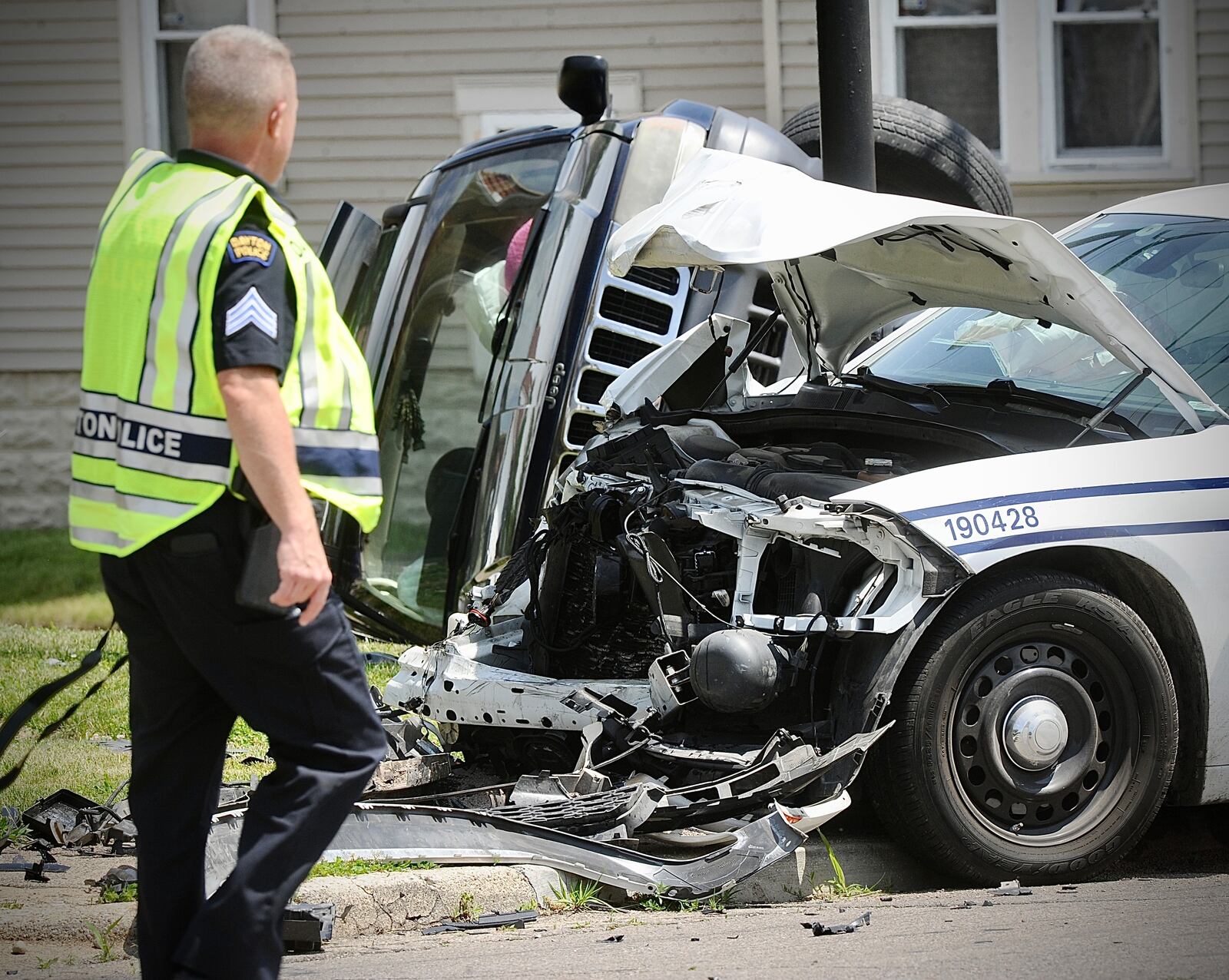 A Dayton police cruiser sustained heavy front-end damage during a crash Thursday, May 23, 2024, at West Third Street and North Decker Avenue. A second vehicle landed on its side. MARSHALL GORBY/STAFF