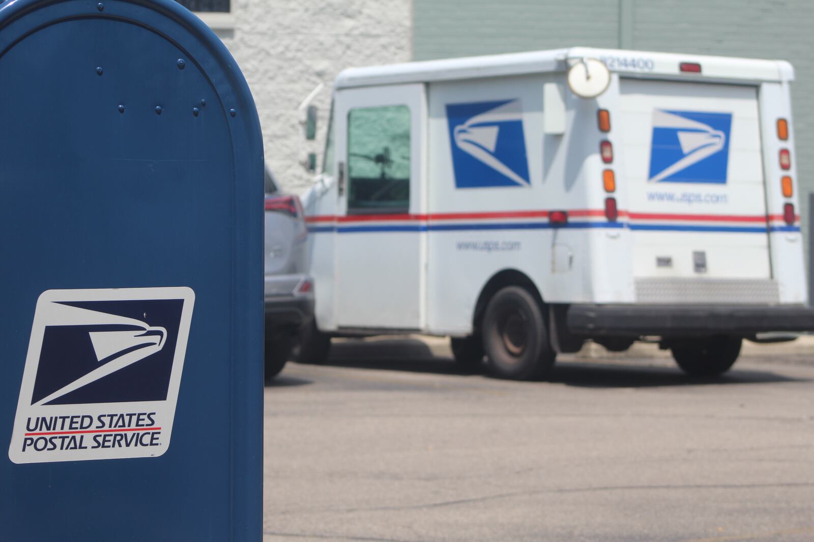 A mailbox and U.S. Postal Service vehicle outside of Dayton's mail processing and distribution center on East Fifth Street. CORNELIUS FROLIK / STAFF