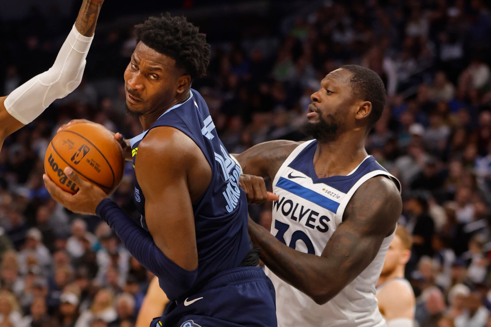 Memphis Grizzlies forward Jaren Jackson Jr., left, works to the basket as Minnesota Timberwolves forward Julius Randle defends him in the second quarter of an NBA basketball game Saturday, Jan. 11, 2025, in Minneapolis. (AP Photo/Bruce Kluckhohn)