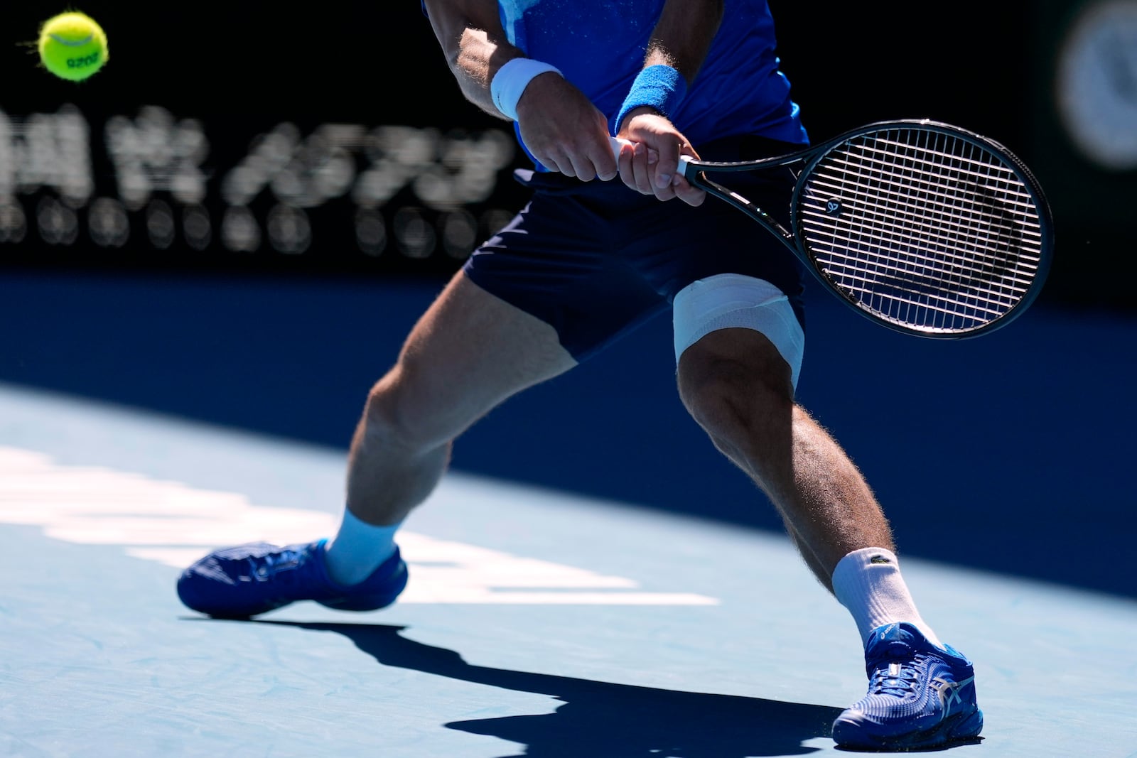 Novak Djokovic of Serbia plays a backhand return to Alexander Zverev of Germany during their semifinal match at the Australian Open tennis championship in Melbourne, Australia, Friday, Jan. 24, 2025. (AP Photo/Asanka Brendon Ratnayake)