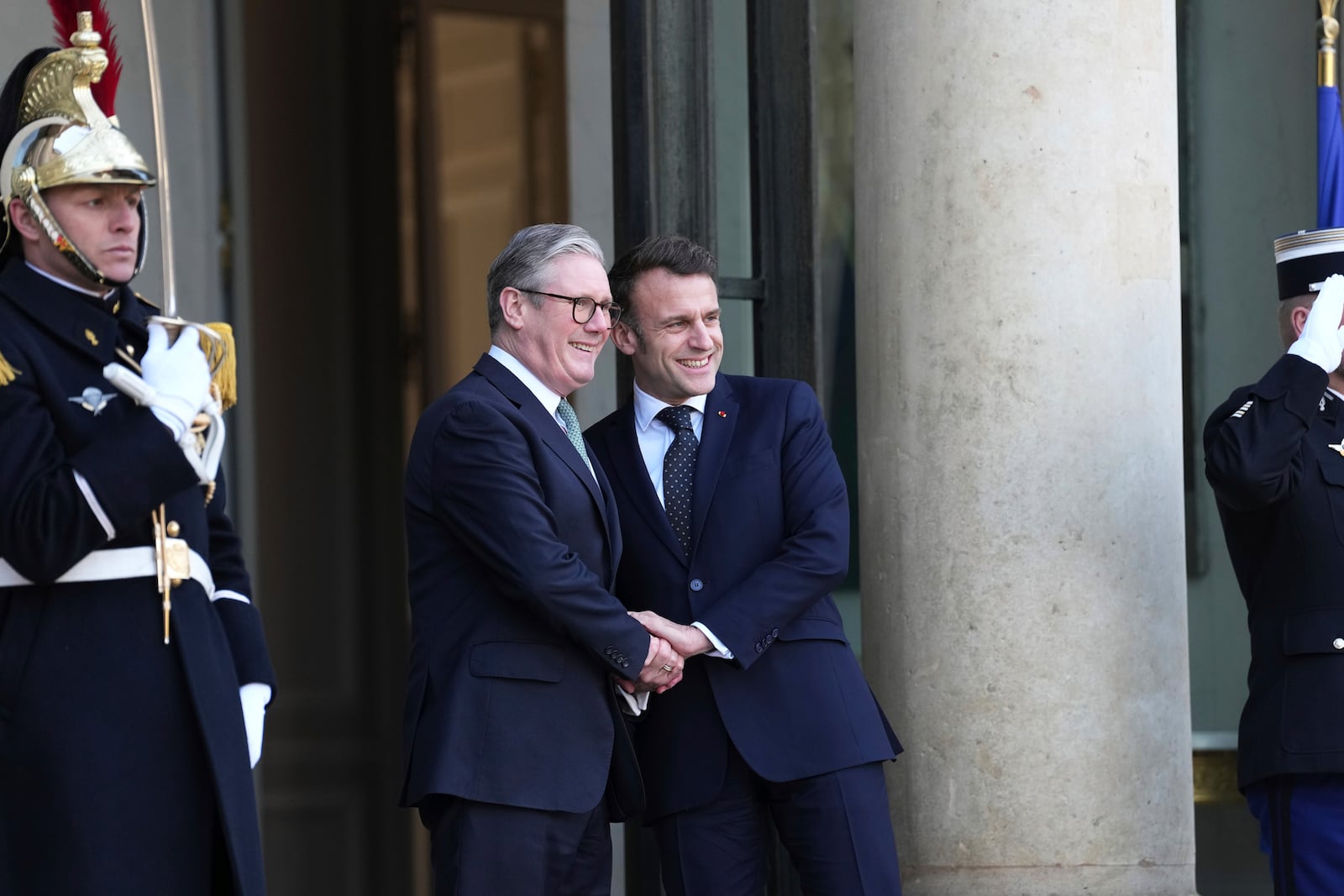 French President Emmanuel Macron, right, greets Britain's Prime Minister Keir Stammer as he arrives for an informal meeting of leaders from key European Union nations and the United Kingdom at the Elysee Palace in Paris, Monday, Feb. 17, 2025. (AP Photo/Aurelien Morissard)