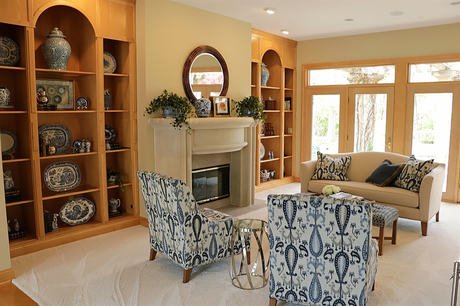 Straight off the foyer is the great room, which has a wall of windows that fill not only the room but also the adjoining foyer with natural light. Flooring treatment separates the space as the great room has light carpeting. Lighted built-in bookcases flank the dramatic curved fireplace. CONTRIBUTED PHOTO BY KATHY TYLER