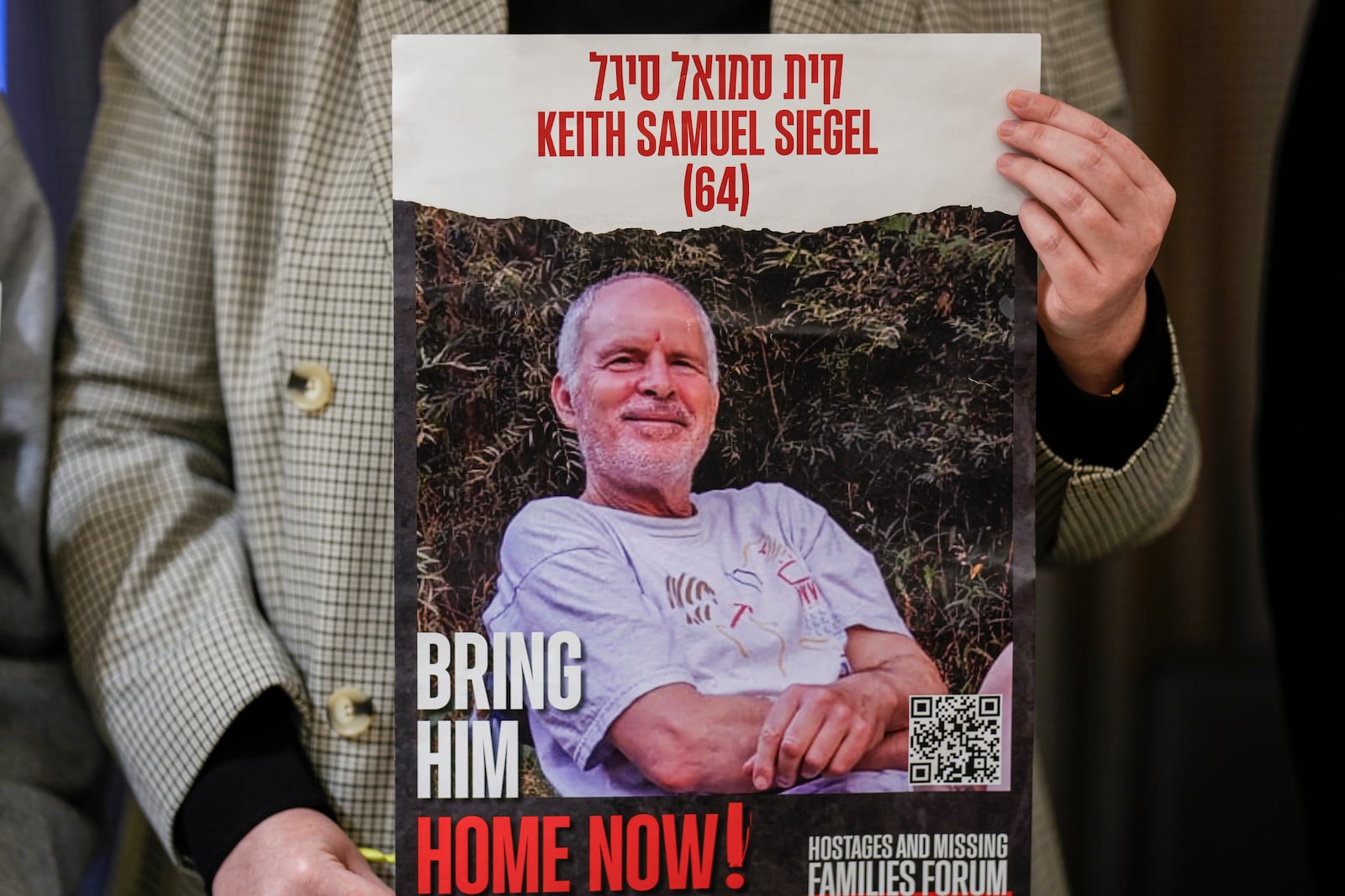 FILE - Tal Wax poses in Madrid on Thursday, Jan. 25, 2024, with a poster showing her uncle Keith Siegel, an Israeli-American hostage held in Gaza since the Oct. 7 attacks by Hamas. (AP Photo/Manu Fernandez, File)