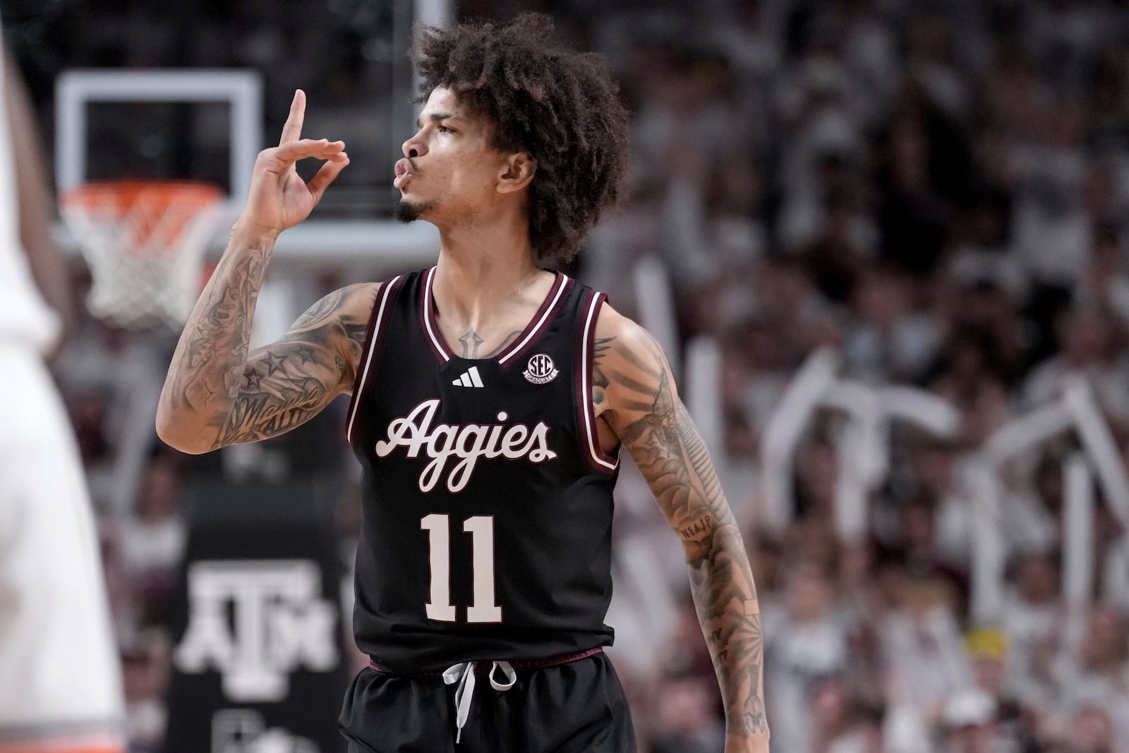 Texas A&M forward Andersson Garcia reacts to the crowd after making a 3-point basket against Auburn during the first half of an NCAA college basketball game, Tuesday, March 4, 2025, in College Station, Texas. (AP Photo/Sam Craft)