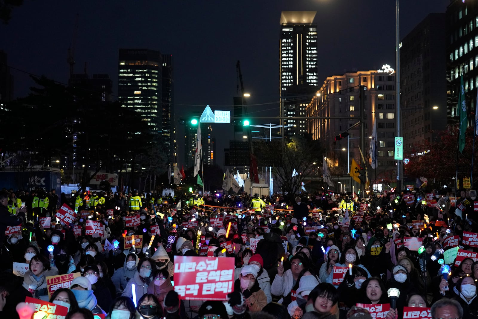 Participants gather to stage a rally demanding South Korean President Yoon Suk Yeol's impeachment, in front of the headquarters of the ruling People Power Party in Seoul, South Korea, Tuesday, Dec. 10, 2024. The banners read "Immediately impeachment Yoon Suk Yeol." (AP Photo/Lee Jin-man)